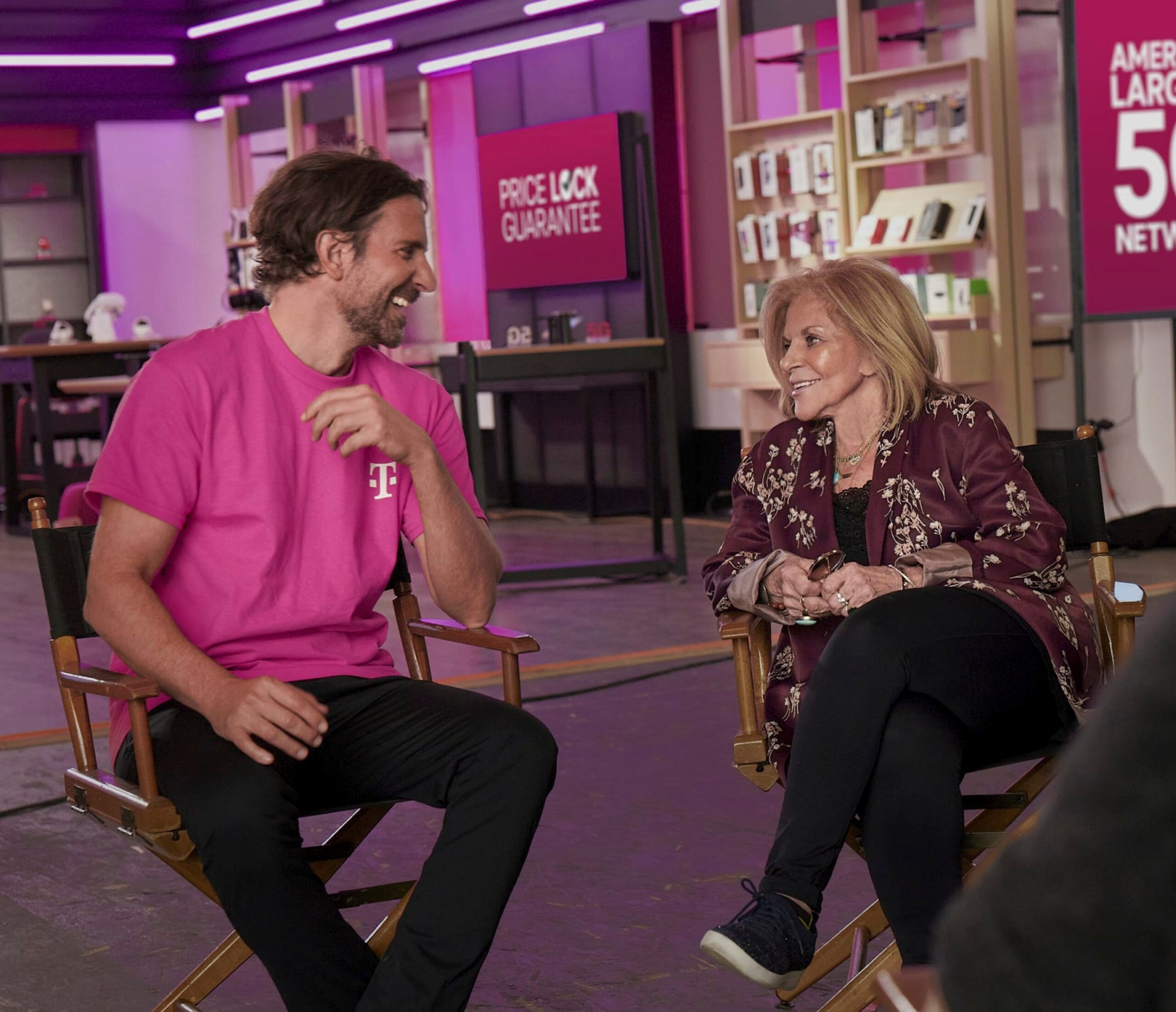 This photo provided by T-Mobile shows Bradley Cooper and his mother Gloria Campano in scene from T-Mobile 2023 Super Bowl NFL football spot. ( T-Mobile via AP)