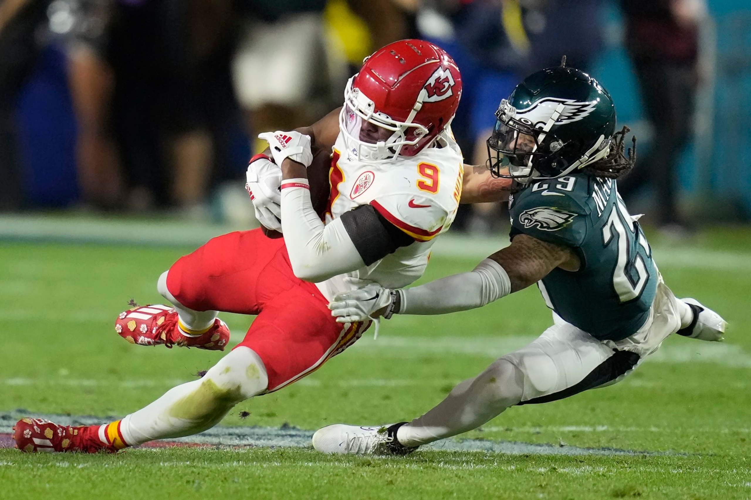 Kansas City Chiefs wide receiver JuJu Smith-Schuster (9) falls to the turf against Philadelphia Eagles cornerback Avonte Maddox (29) during the second half of the NFL Super Bowl 57 football game, Sunday, Feb. 12, 2023, in Glendale, Ariz. (AP Photo/Ashley Landis)