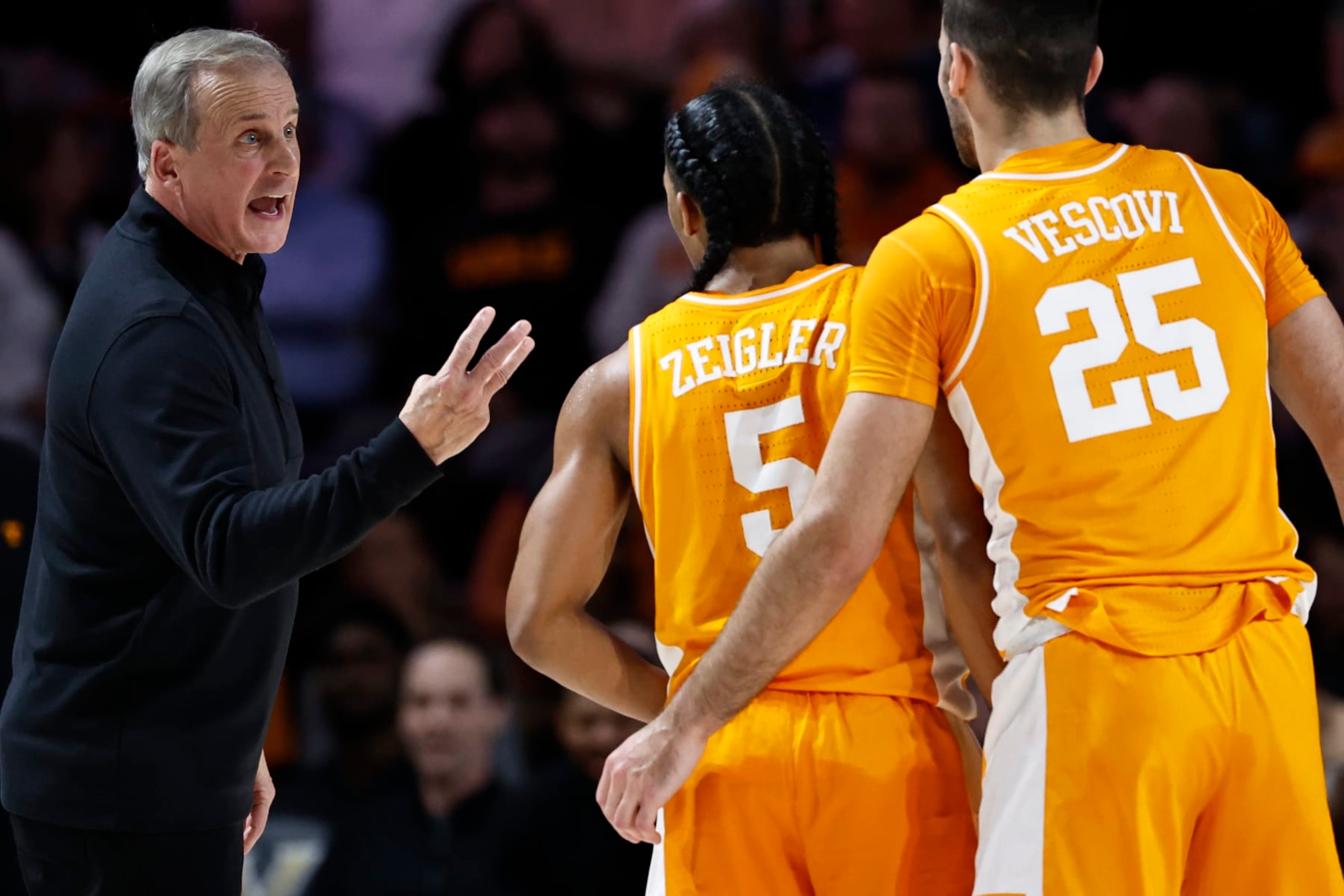 Tennessee head coach Rick Barnes talks with guard Zakai Zeigler (5 and guard Santiago Vescovi (25) during the first half of the team's NCAA college basketball game against Vanderbilt, Wednesday, Feb. 8, 2023, in Nashville, Tenn. (AP Photo/Wade Payne)
