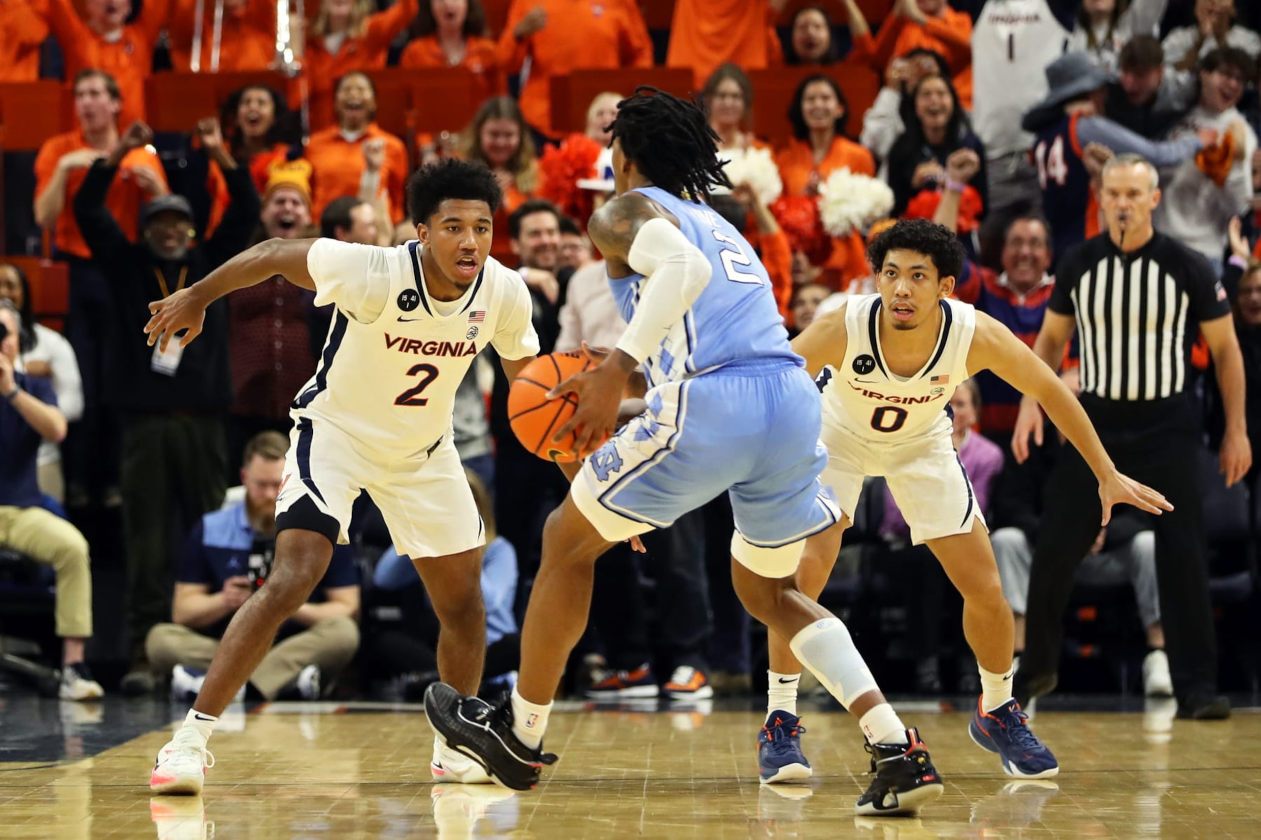CHARLOTTESVILLE, VA - JANUARY 10: Reece Beekman #2 and Kihei Clark #0 of the Virginia Cavaliers defend Caleb Love #2 of the North Carolina Tar Heels in the second half during a game at John Paul Jones Arena on January 10, 2023 in Charlottesville, Virginia. (Photo by Ryan M. Kelly/Getty Images)