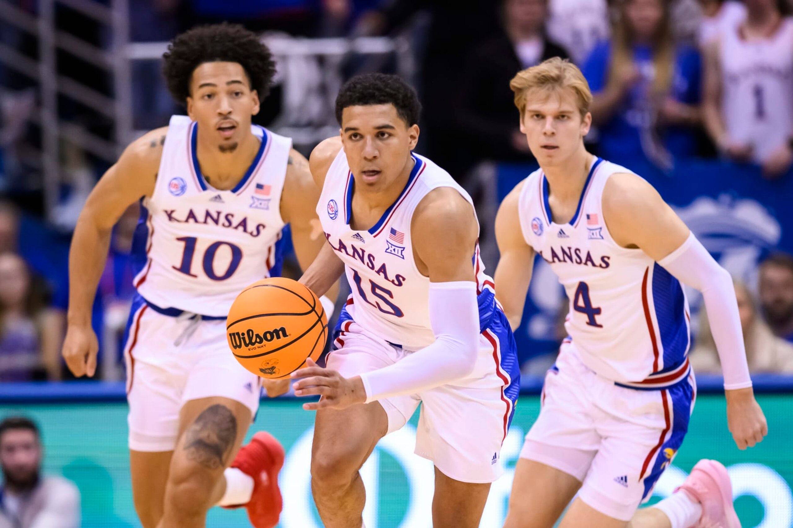 Kansas guard Kevin McCullar Jr. (15) brings the ball upcourt followed by forward Jalen Wilson (10) and guard Gradey Dick (4) during the first half of an NCAA college basketball game against Omaha in Lawrence, Kan., Monday, Nov. 7, 2022. (AP Photo/Reed Hoffmann)