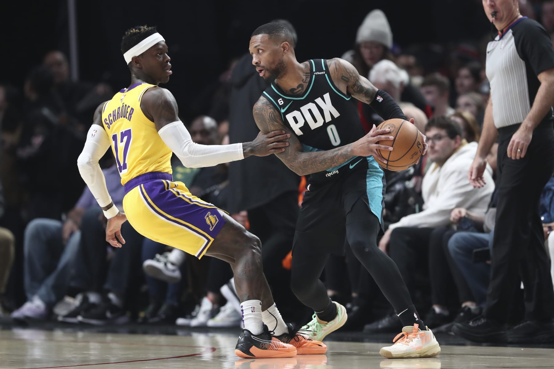 PORTLAND, OREGON - FEBRUARY 13: Dennis Schroder #17 of the Los Angeles Lakers defends against Damian Lillard #0 of the Portland Trail Blazers during the first quarter at Moda Center on February 13, 2023 in Portland, Oregon. NOTE TO USER: User expressly acknowledges and agrees that, by downloading and or using this photograph, user is consenting to the terms and conditions of the Getty Images License Agreement. (Photo by Amanda Loman/Getty Images)