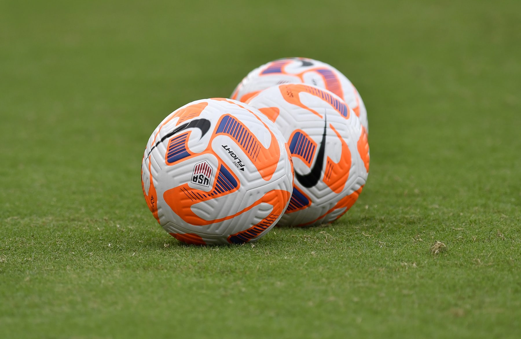WASHINGTON, DC - SEPTEMBER 06: A close up view of Nike Flight soccer balls on a natural grass field during the Nigeria versus United States Womens National Team (USWNT USA) game on September 06, 2022, at Audi Field in Washington, D.C.. (Photo by Randy Litzinger/Icon Sportswire via Getty Images)