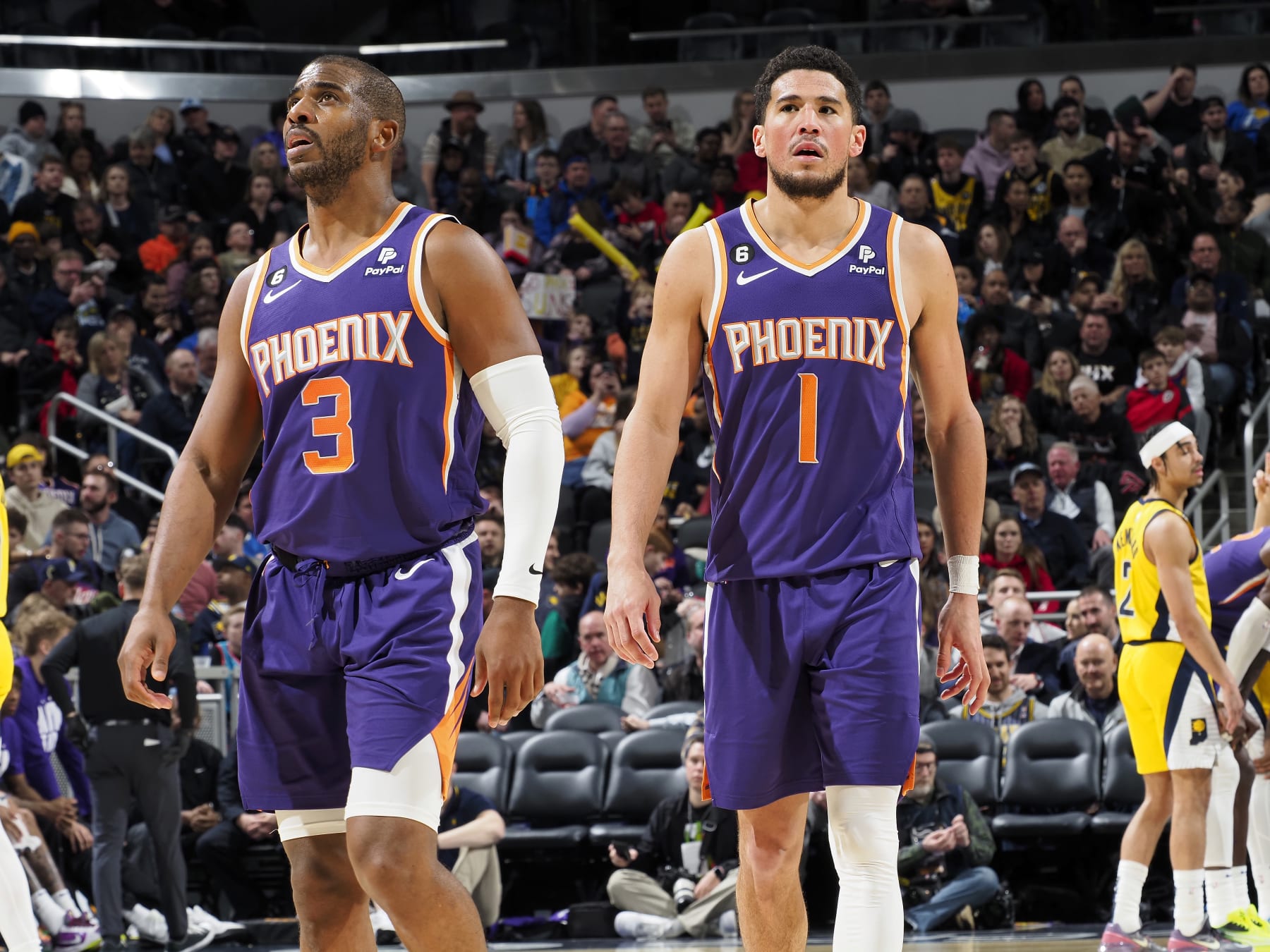 INDIANAPOLIS, IN - FEBRUARY 10: Chris Paul #3 and Devin Booker #1 of the Phoenix Suns looks on during the game against the Indiana Pacers on February 10, 2023 at Gainbridge Fieldhouse in Indianapolis, Indiana. NOTE TO USER: User expressly acknowledges and agrees that, by downloading and or using this Photograph, user is consenting to the terms and conditions of the Getty Images License Agreement. Mandatory Copyright Notice: Copyright 2023 NBAE (Photo by Ron Hoskins/NBAE via Getty Images)