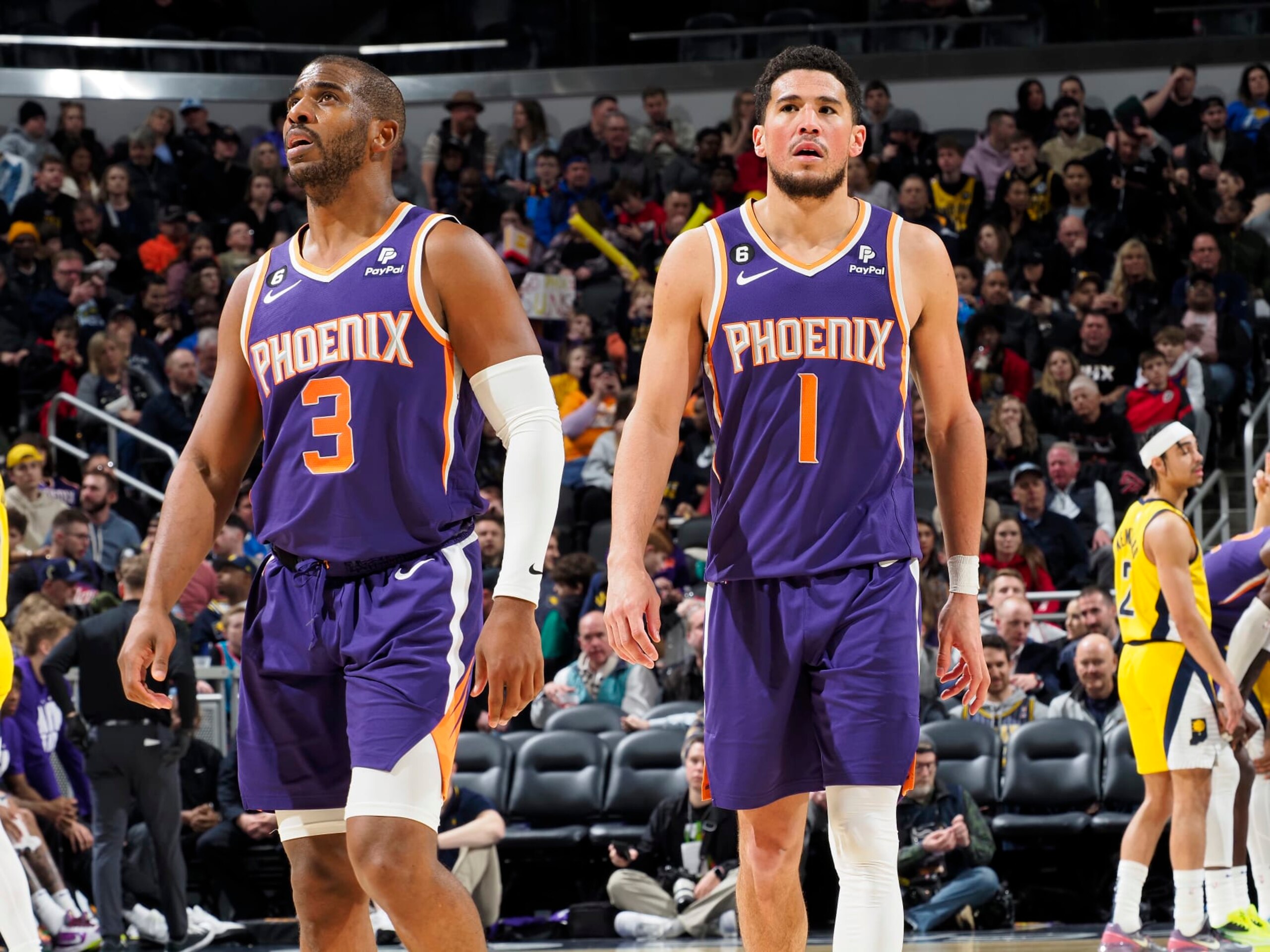 INDIANAPOLIS, IN - FEBRUARY 10: Chris Paul #3 and Devin Booker #1 of the Phoenix Suns looks on during the game against the Indiana Pacers on February 10, 2023 at Gainbridge Fieldhouse in Indianapolis, Indiana. NOTE TO USER: User expressly acknowledges and agrees that, by downloading and or using this Photograph, user is consenting to the terms and conditions of the Getty Images License Agreement. Mandatory Copyright Notice: Copyright 2023 NBAE (Photo by Ron Hoskins/NBAE via Getty Images)