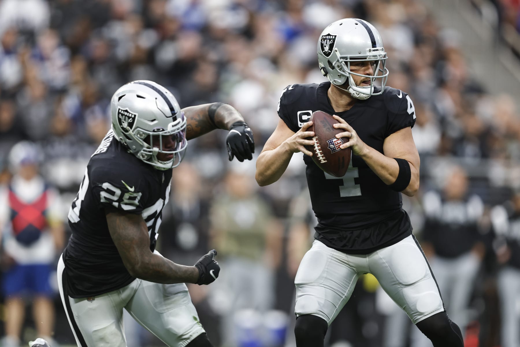 LAS VEGAS, NEVADA - NOVEMBER 13: Derek Carr #4 of the Las Vegas Raiders fakes the hand off to Josh Jacobs #28 of the Las Vegas Raiders and looks to pass during an NFL game between the Las Vegas Raiders and the Indianapolis Colts at Allegiant Stadium on November 13, 2022 in Las Vegas, Nevada. (Photo by Michael Owens/Getty Images)