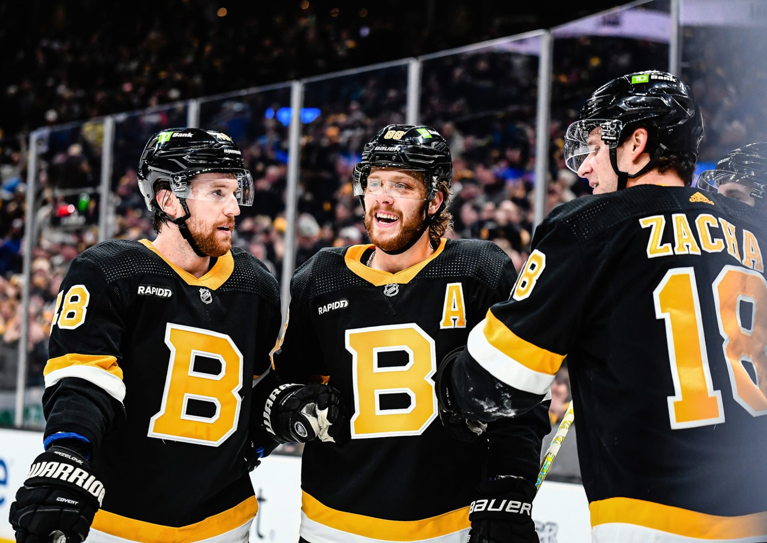 BOSTON, MASSACHUSETTS - JANUARY 16: David Pastrnak #88 of the Boston Bruins celebrates with Matt Grzelcyk #48 and Pavel Zacha #18 after scoring a first period goal against the Philadelphia FlyersTD Garden on January 16, 2023 in Boston, Massachusetts. (Photo by China Wong/NHLI via Getty Images)