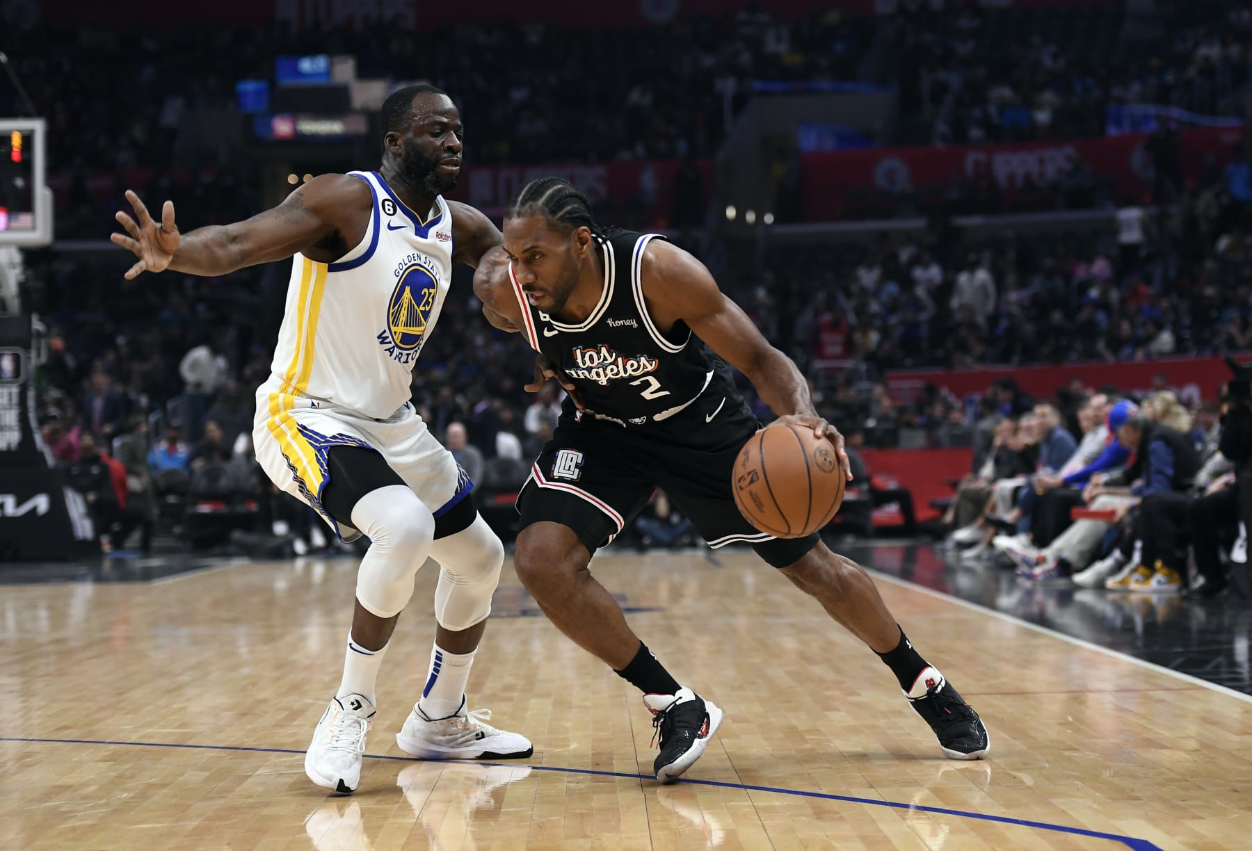 LOS ANGELES, CA - FEBRUARY 14: Kawhi Leonard #2 of the Los Angeles Clippers drives against Draymond Green #23 of the Golden State Warriors during the first half at Crypto.com Arena on February 14, 2023 in Los Angeles, California. NOTE TO USER: User expressly acknowledges and agrees that, by downloading and or using this photograph, User is consenting to the terms and conditions of the Getty Images License Agreement. (Photo by Kevork Djansezian/Getty Images)