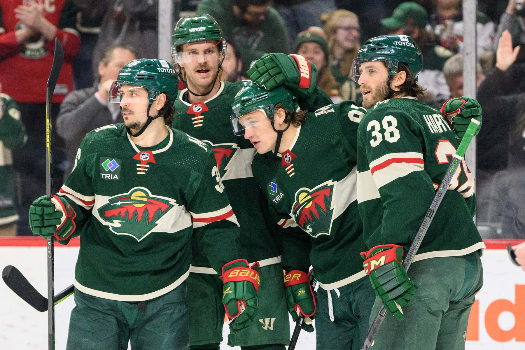 ST. PAUL, MN - FEBRUARY 13: Minnesota Wild Left Wing Kirill Kaprizov (97) is congratulated on his goal by Minnesota Wild Right Wing Mats Zuccarello (36), Minnesota Wild Defenceman Jon Merrill (4), and Minnesota Wild Center Ryan Hartman (38) during the second period of a game between the Minnesota Wild and Florida Panthers on February 13, 2023, at Xcel Energy Center in St. Paul, MN.(Photo by Nick Wosika/Icon Sportswire via Getty Images)