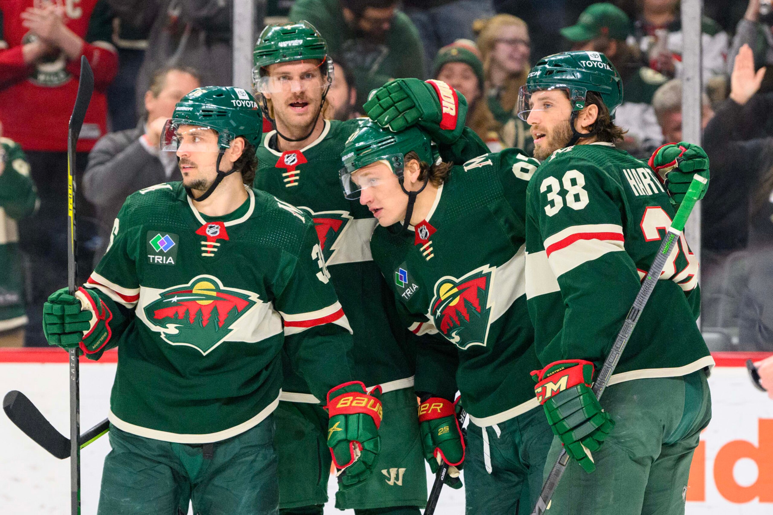 ST. PAUL, MN - FEBRUARY 13: Minnesota Wild Left Wing Kirill Kaprizov (97) is congratulated on his goal by Minnesota Wild Right Wing Mats Zuccarello (36), Minnesota Wild Defenceman Jon Merrill (4), and Minnesota Wild Center Ryan Hartman (38) during the second period of a game between the Minnesota Wild and Florida Panthers on February 13, 2023, at Xcel Energy Center in St. Paul, MN.(Photo by Nick Wosika/Icon Sportswire via Getty Images)