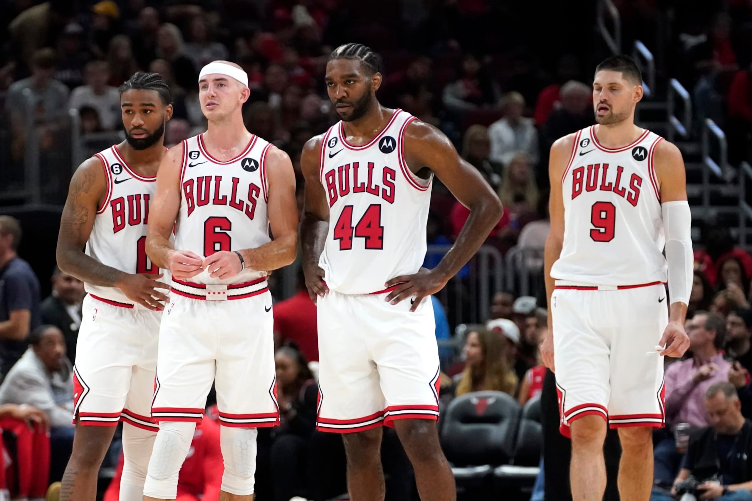 Chicago Bulls from left, guard Coby White, Alex Caruso, Patrick Williams, and Nikola Vucevic wait for play to resume during an NBA preseason basketball game against the Milwaukee Bucks Tuesday, Oct. 11, 2022, in Chicago.(AP Photo/Charles Rex Arbogast)