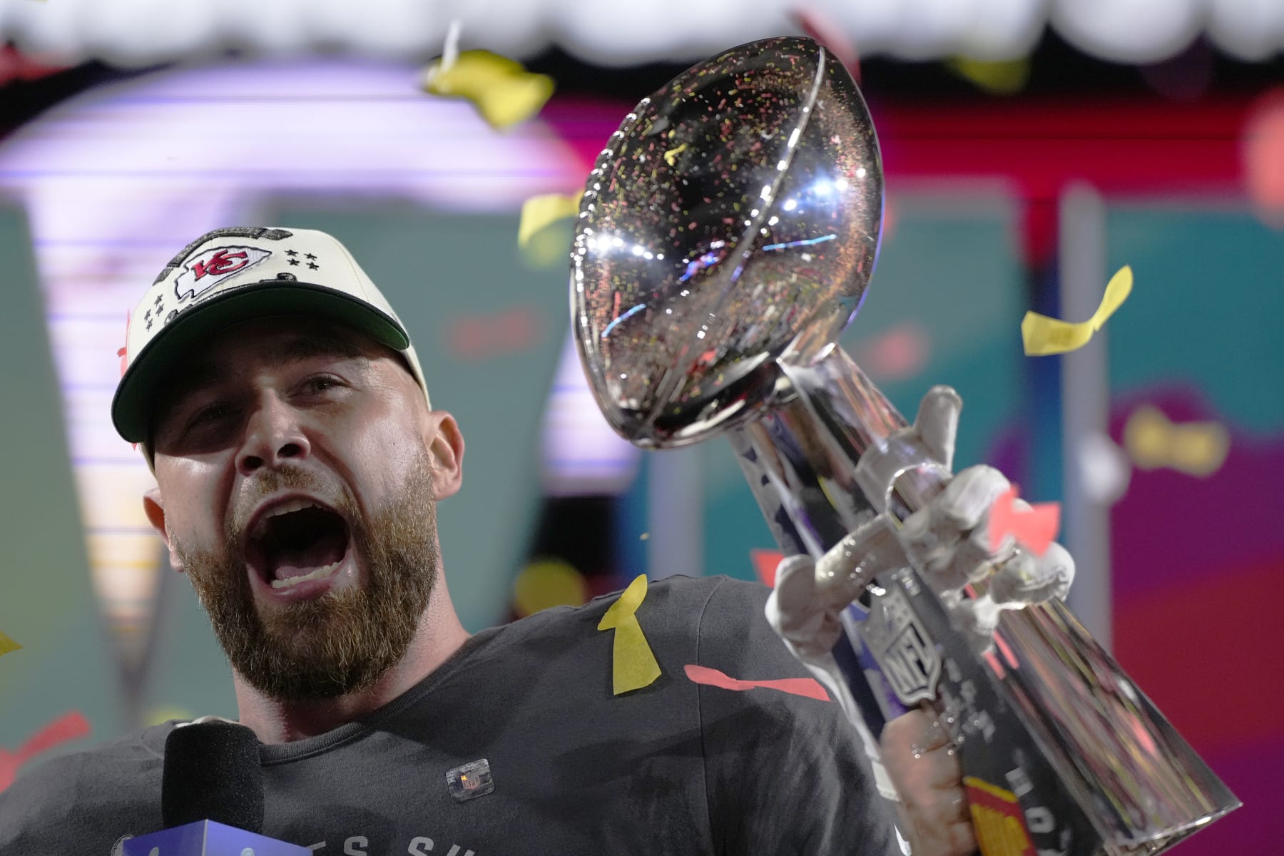 Kansas City Chiefs tight end Travis Kelce (87) celebrates with the trophy after the NFL Super Bowl 57 football game, Sunday, Feb. 12, 2023, in Glendale, Ariz. The Chiefs defeated the Philadelphia Eagles 38-35. (AP Photo/Matt Slocum)