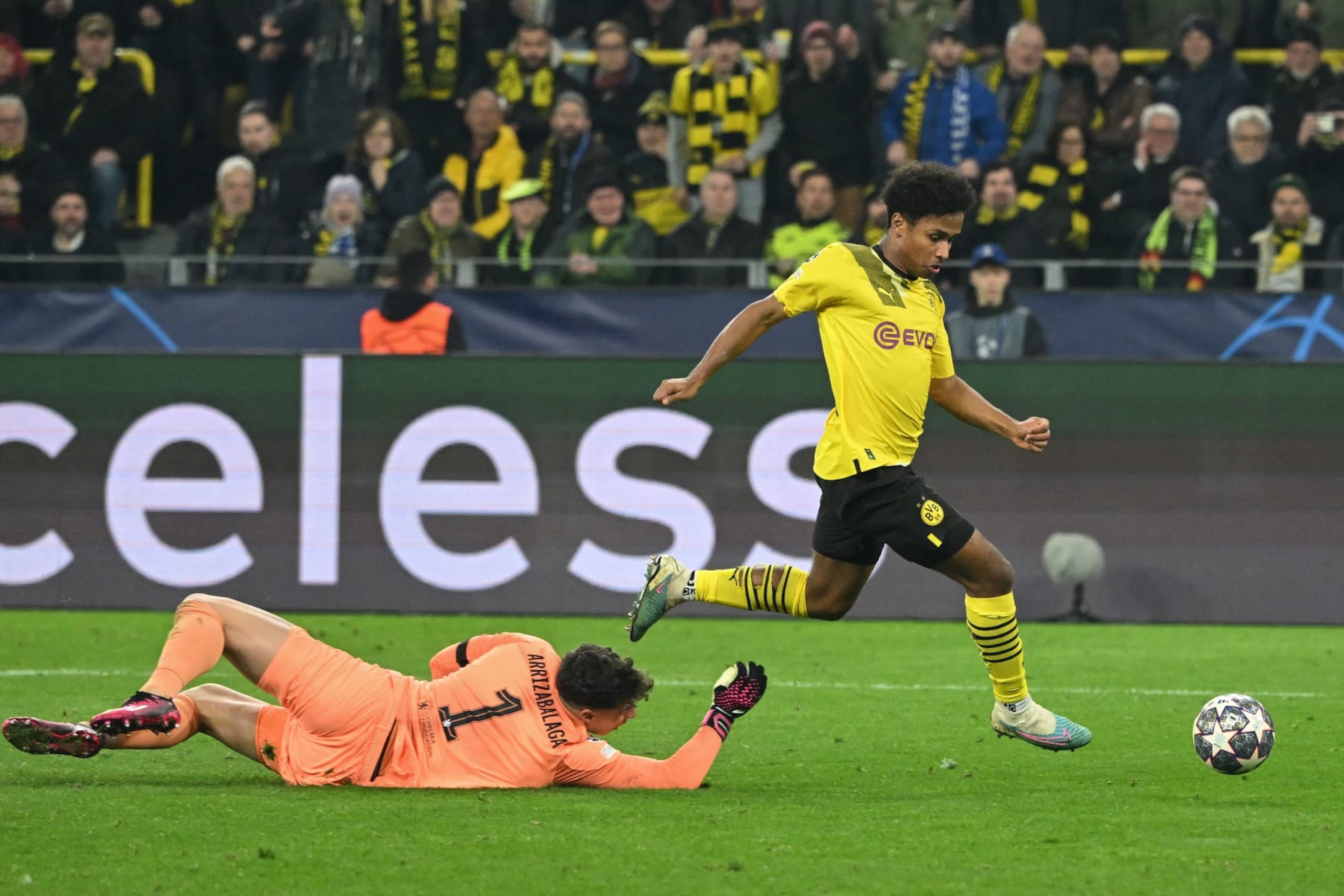 Dortmund's German forward Karim Adeyemi (R) goes past Chelsea's Spanish goalkeeper Kepa Arrizabalaga to score the opening goal during the UEFA Champions League, first-leg, round of 16 football match BVB Borussia Dortmund vs Chelsea FC, in Dortmund, western Germany, on February 15, 2023. (Photo by INA FASSBENDER / AFP) (Photo by INA FASSBENDER/AFP via Getty Images)