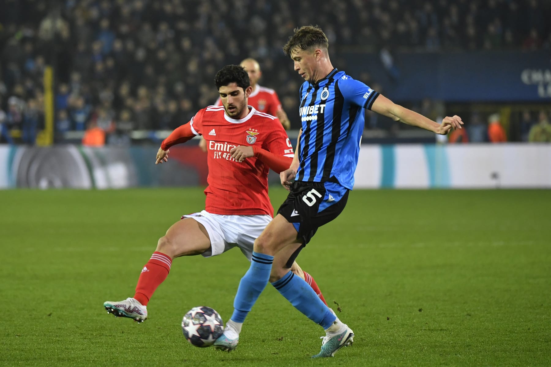 Brugge's Jack Hendry, right, challenges for the ball with Benfica's Goncalo Guedes during the Champions League round of 16 first leg soccer match between Club Brugge and Benfica at the Jan Breydel stadium in Bruges, Belgium, Wednesday, Feb. 15, 2023. (AP Photo/Geert Vanden Wijngaert)