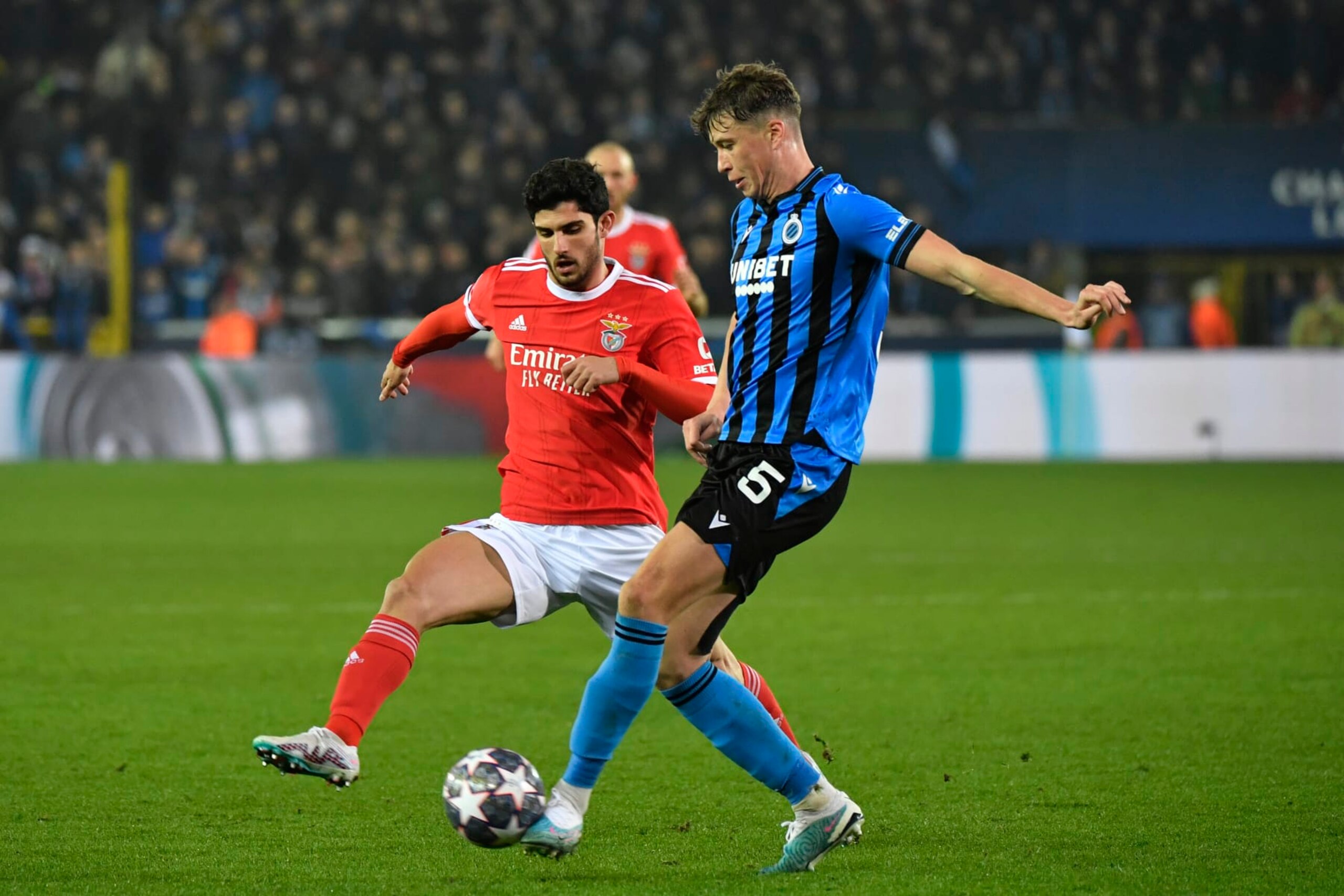 Brugge's Jack Hendry, right, challenges for the ball with Benfica's Goncalo Guedes during the Champions League round of 16 first leg soccer match between Club Brugge and Benfica at the Jan Breydel stadium in Bruges, Belgium, Wednesday, Feb. 15, 2023. (AP Photo/Geert Vanden Wijngaert)