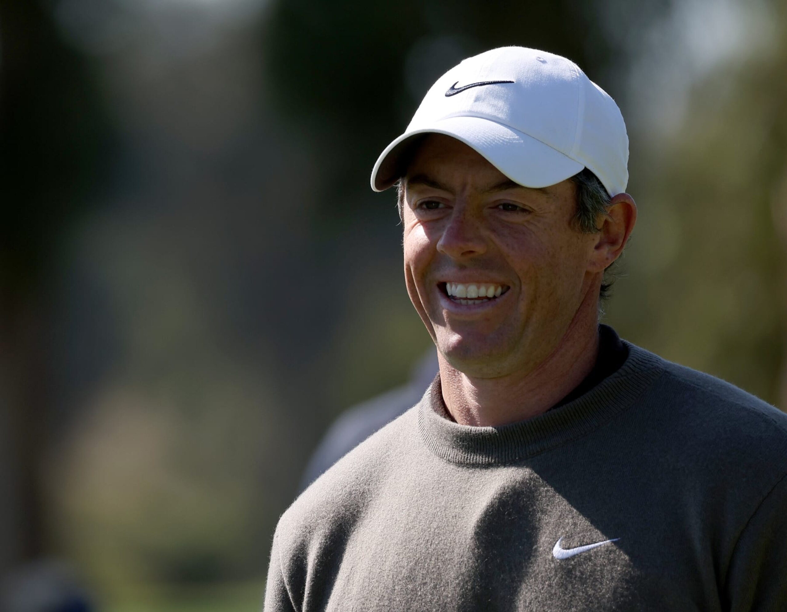 PACIFIC PALISADES, CALIFORNIA - FEBRUARY 15: Rory McIlroy of Ireland smiles as he comes off the 18th green during a pro-am before the Genesis Invitational at Riviera Country Club on February 15, 2023 in Pacific Palisades, California. (Photo by Harry How/Getty Images)