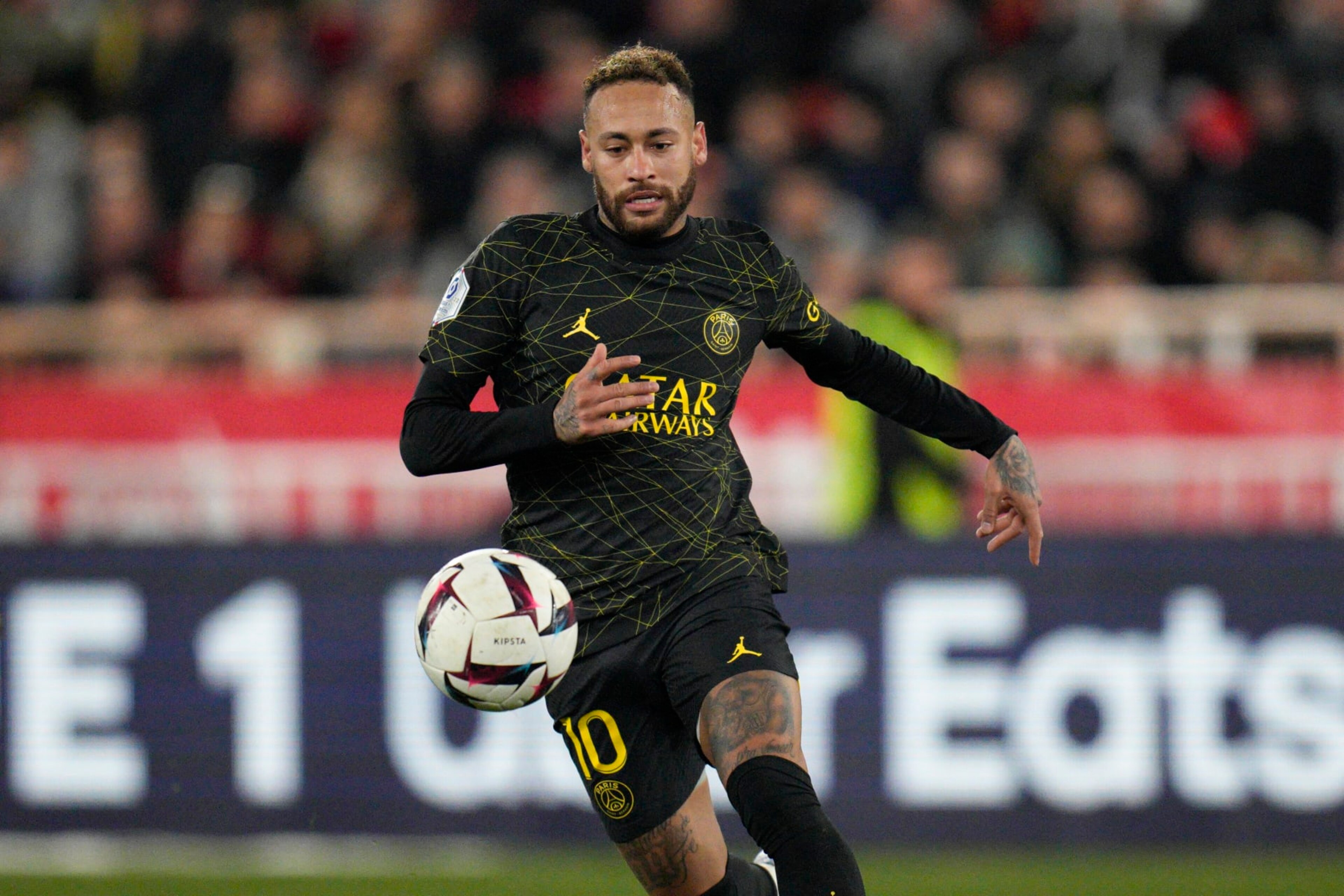 PSG's Neymar goes for the ball during a French League One soccer match between Monaco and Paris Saint-Germain at the Stade Louis II in Monaco, Saturday, Feb. 11, 2023. (AP Photo/Daniel Cole)