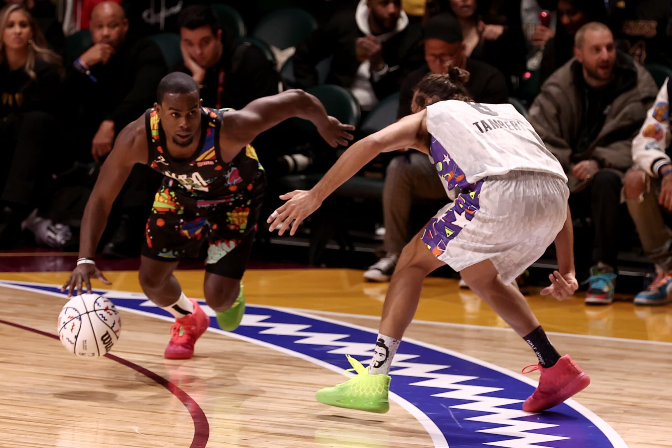 CLEVELAND, OHIO - FEBRUARY 18: Alex Toussaint #25 of Team Walton dribbles past Gianmarco Tamberi #8 of Team Nique during the Ruffles NBA All-Star Celebrity Game during the 2022 NBA All-Star Weekend at Wolstein Center on February 18, 2022 in Cleveland, Ohio. NOTE TO USER: User expressly acknowledges and agrees that, by downloading and/or using this Photograph, user is consenting to the terms and conditions of the Getty Images License Agreement.  (Photo by Arturo Holmes/Getty Images)