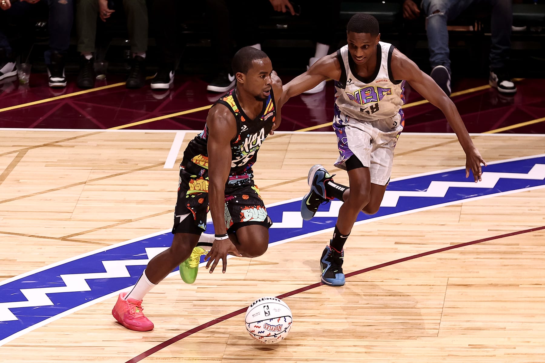 CLEVELAND, OHIO - FEBRUARY 18: Alex Toussaint #25 of Team Walton dribbles past Mayor Justin Bibb #58 of Team Nique during the Ruffles NBA All-Star Celebrity Game during the 2022 NBA All-Star Weekend at Wolstein Center on February 18, 2022 in Cleveland, Ohio. NOTE TO USER: User expressly acknowledges and agrees that, by downloading and/or using this Photograph, user is consenting to the terms and conditions of the Getty Images License Agreement.  (Photo by Arturo Holmes/Getty Images)