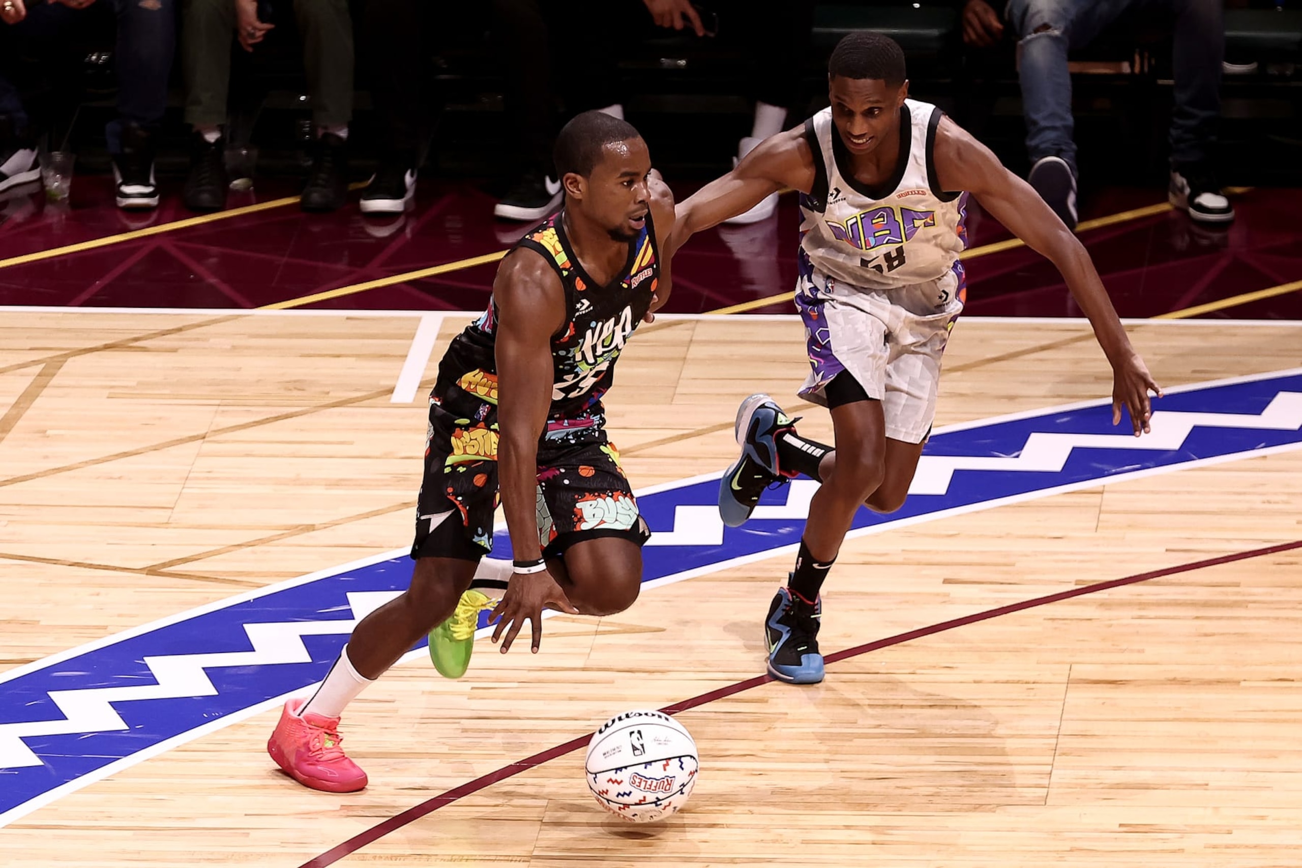 CLEVELAND, OHIO - FEBRUARY 18: Alex Toussaint #25 of Team Walton dribbles past Mayor Justin Bibb #58 of Team Nique during the Ruffles NBA All-Star Celebrity Game during the 2022 NBA All-Star Weekend at Wolstein Center on February 18, 2022 in Cleveland, Ohio. NOTE TO USER: User expressly acknowledges and agrees that, by downloading and/or using this Photograph, user is consenting to the terms and conditions of the Getty Images License Agreement.  (Photo by Arturo Holmes/Getty Images)