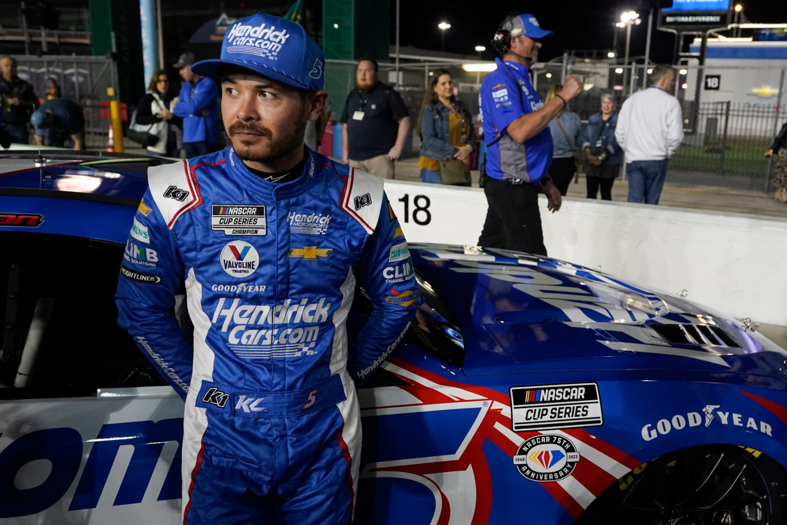 Kyle Larson stands by his car on pit road after qualifying for the NASCAR Daytona 500 auto race at Daytona International Speedway, Wednesday, Feb. 15, 2023, in Daytona Beach, Fla. (AP Photo/John Raoux)