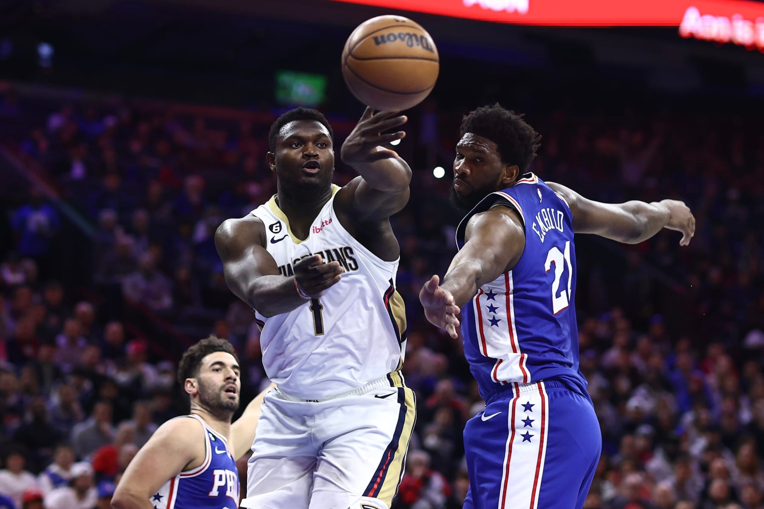 PHILADELPHIA, PENNSYLVANIA - JANUARY 02: Zion Williamson #1 of the New Orleans Pelicans passes past Joel Embiid #21 of the Philadelphia 76ers during the first quarter at Wells Fargo Center on January 02, 2023 in Philadelphia, Pennsylvania. NOTE TO USER: User expressly acknowledges and agrees that, by downloading and or using this photograph, User is consenting to the terms and conditions of the Getty Images License Agreement. (Photo by Tim Nwachukwu/Getty Images) PHILADELPHIA, PENNSYLVANIA - JANUARY 02: Zion Williamson #1 of the New Orleans Pelicans passes past Joel Embiid #21 of the Philadelphia 76ers during the first quarter at Wells Fargo Center on January 02, 2023 in Philadelphia, Pennsylvania. NOTE TO USER: User expressly acknowledges and agrees that, by downloading and or using this photograph, User is consenting to the terms and conditions of the Getty Images License Agreement. (Photo by Tim Nwachukwu/Getty Images)