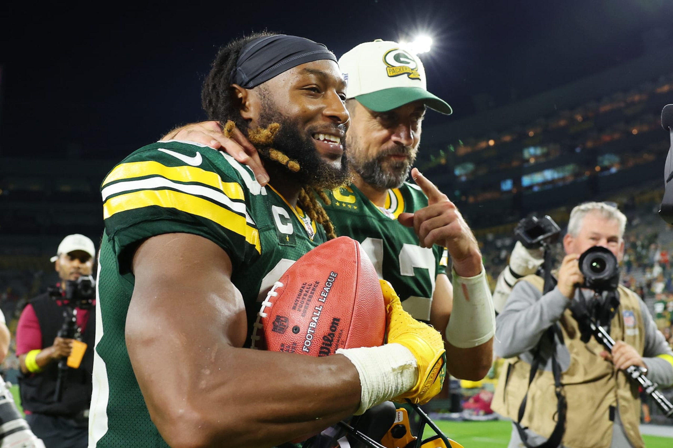 GREEN BAY, WISCONSIN - SEPTEMBER 18: Aaron Jones #33 and Aaron Rodgers #12 of the Green Bay Packers celebrate after defeating the Chicago Bears at Lambeau Field on September 18, 2022 in Green Bay, Wisconsin. (Photo by Michael Reaves/Getty Images)