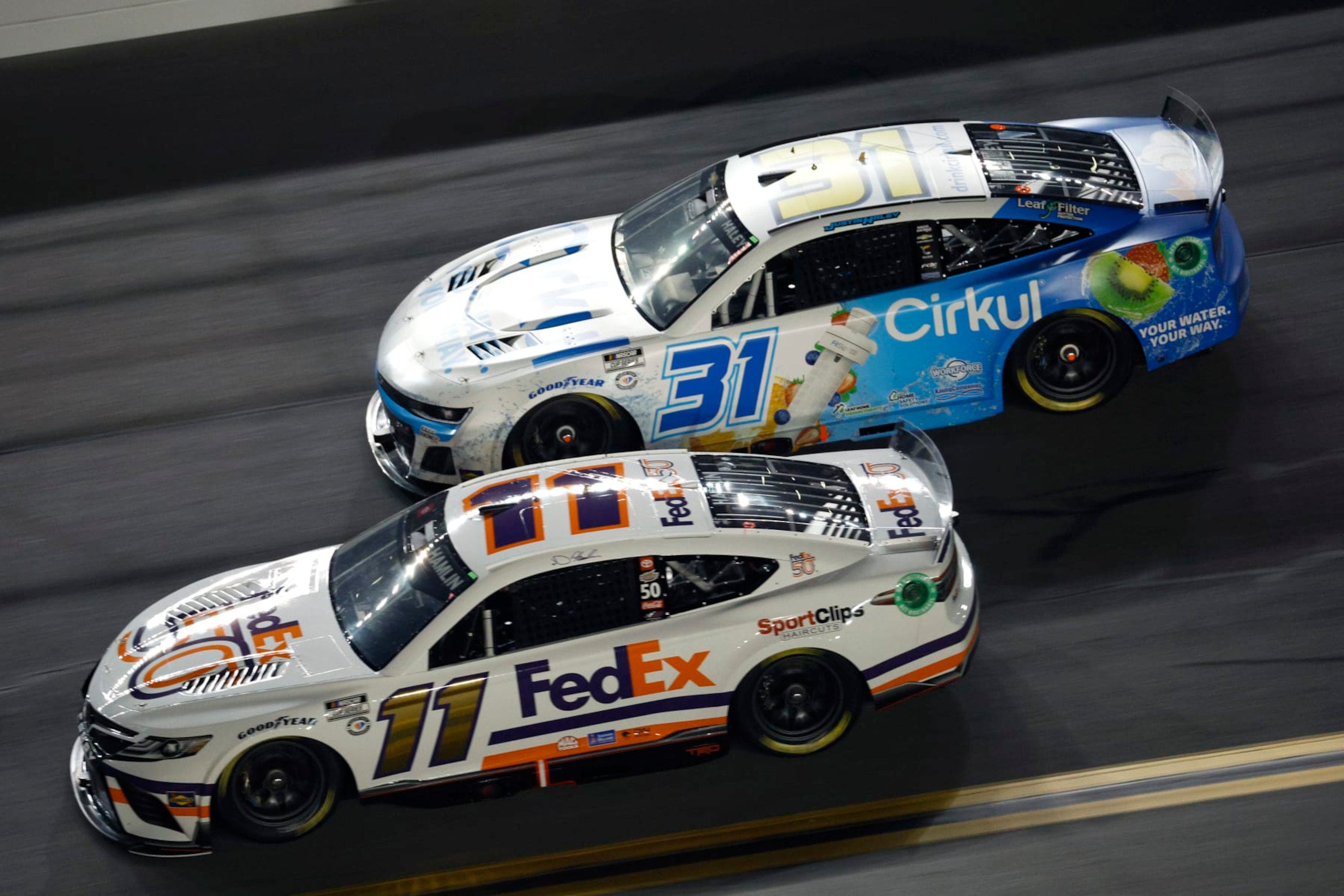 DAYTONA BEACH, FLORIDA - FEBRUARY 16: Denny Hamlin, driver of the #11 FedEx 50 Toyota, and Justin Haley, driver of the #31 Cirkul Chevrolet, race during the NASCAR Cup Series Bluegreen Vacations Duel #2 at Daytona International Speedway on February 16, 2023 in Daytona Beach, Florida. (Photo by Jared C. Tilton/Getty Images)