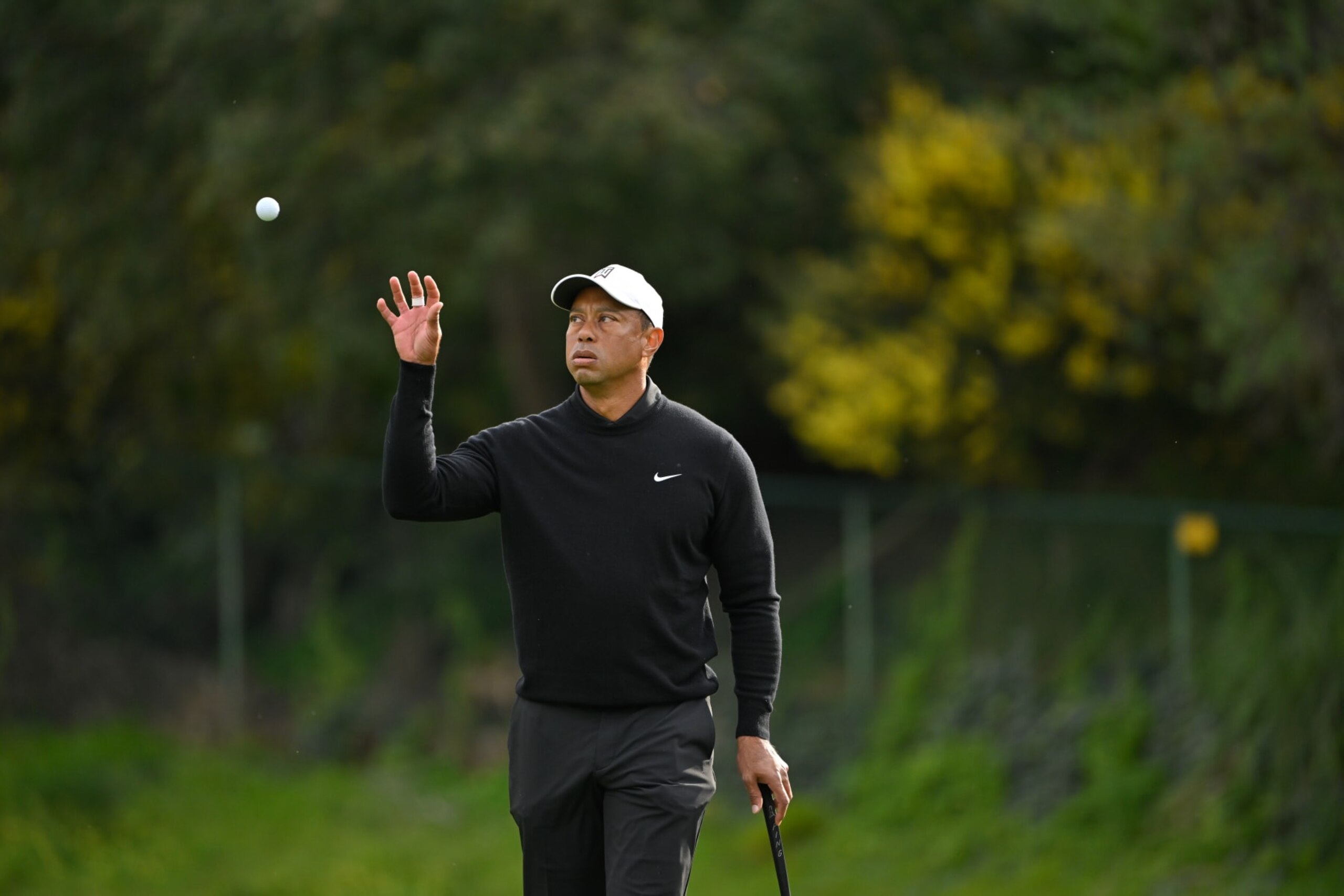 PACIFIC PALISADES, CALIFORNIA - FEBRUARY 17: Tiger Woods catches a ball on the 13th green during the second round of The Genesis Invitational at Riviera Country Club on February 17, 2023 in Pacific Palisades, California. (Photo by Ben Jared/PGA TOUR via Getty Images)