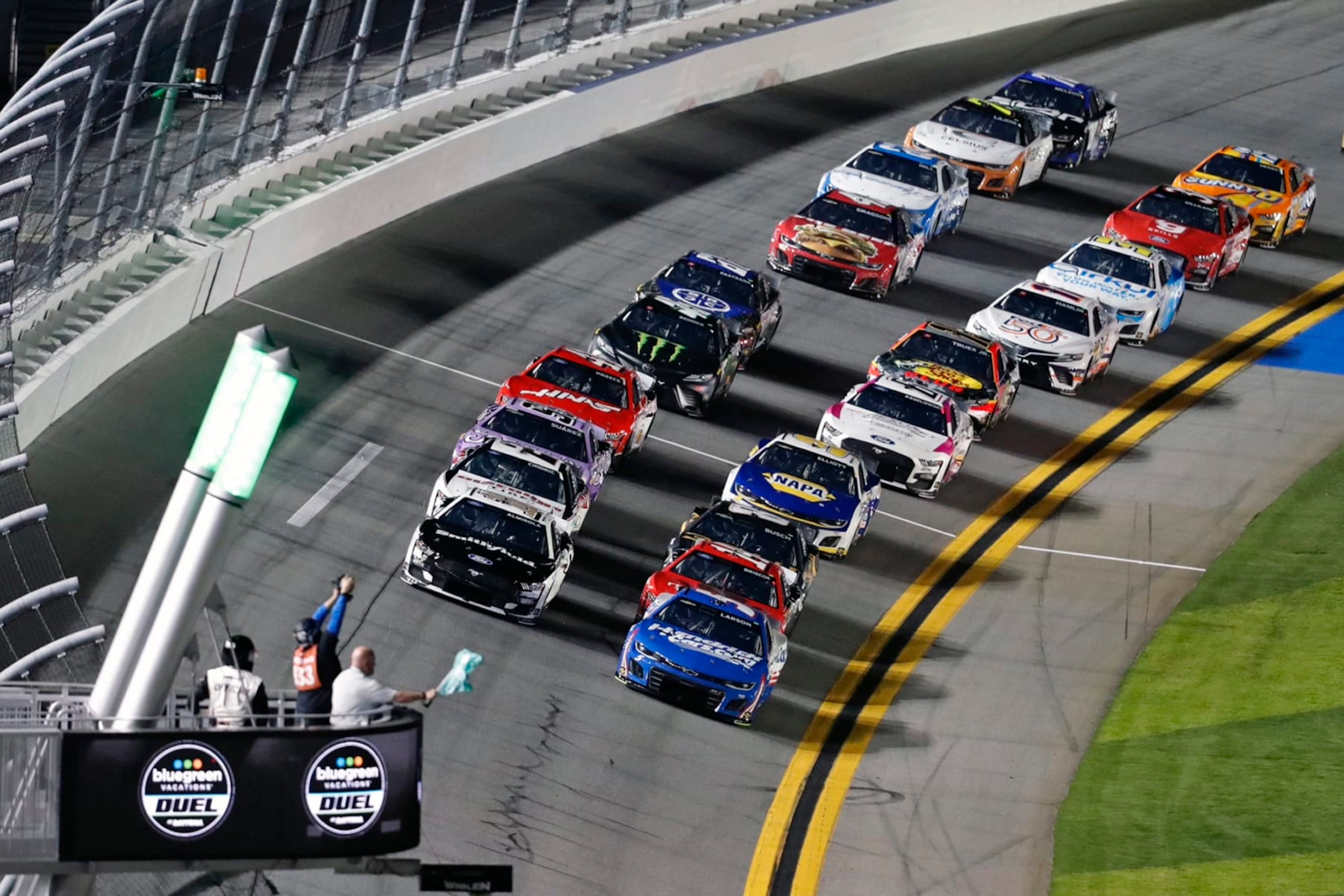Kyle Larson, front right, and Aric Almirola, front left, take the green flag as they lead the field to start the second of two qualifying auto races for the NASCAR Daytona 500 at Daytona International Speedway, Thursday, Feb. 16, 2023, in Daytona Beach, Fla. (AP Photo/David Graham)