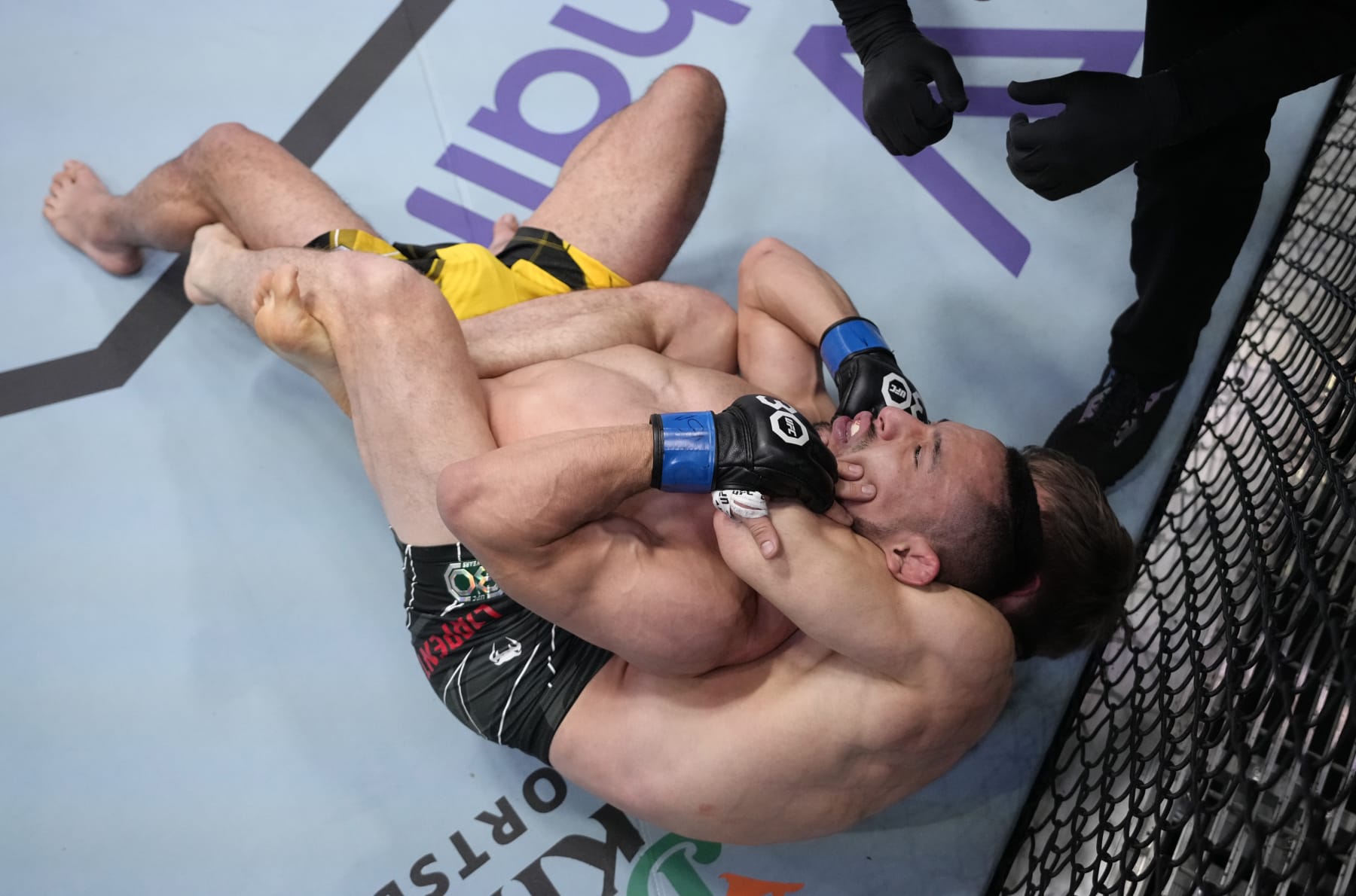 LAS VEGAS, NEVADA - FEBRUARY 18: (R-L) Clayton Carpenter secures a rear choke submission against Juancamilo Ronderos of Colombia in a flyweight fight during the UFC Fight Night event at UFC APEX on February 18, 2023 in Las Vegas, Nevada. (Photo by Jeff Bottari/Zuffa LLC via Getty Images)