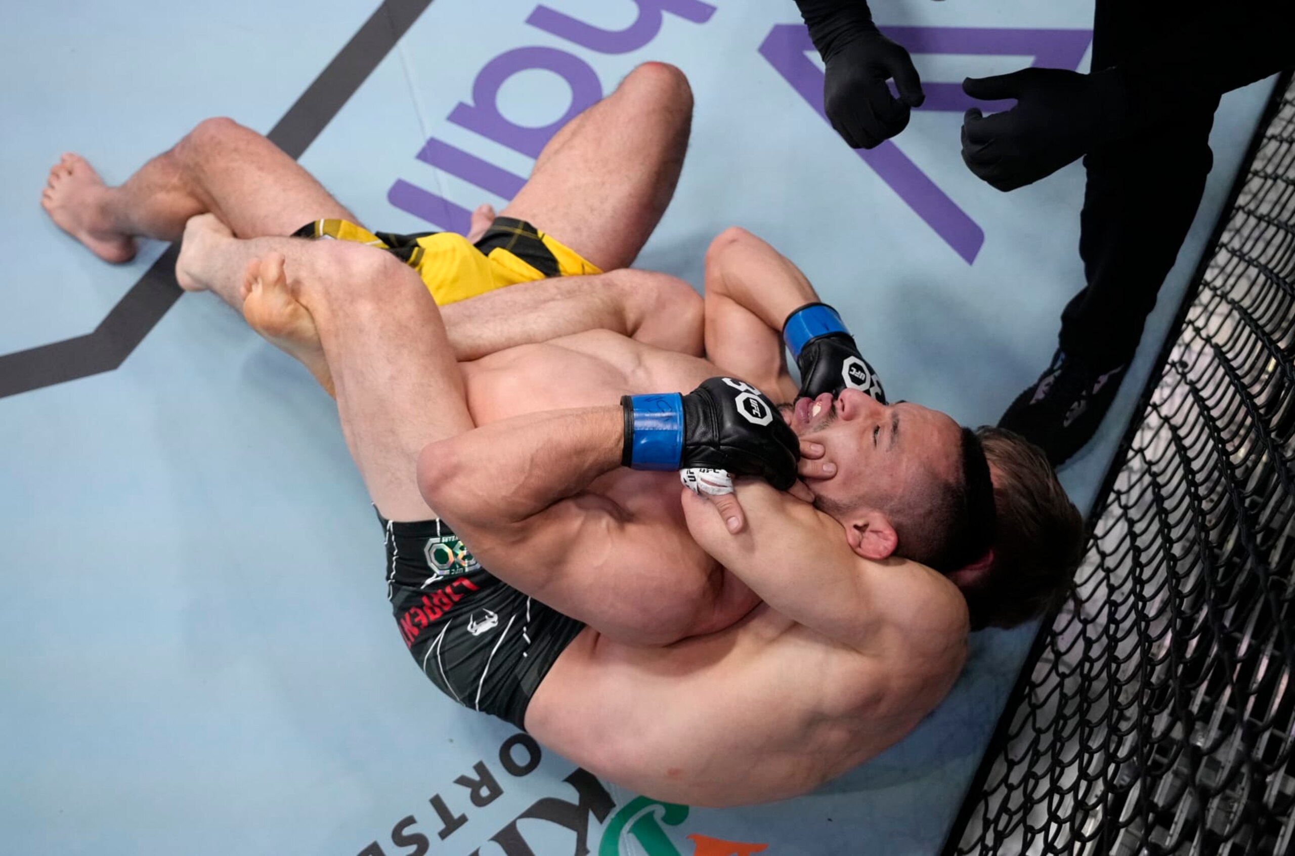 LAS VEGAS, NEVADA - FEBRUARY 18: (R-L) Clayton Carpenter secures a rear choke submission against Juancamilo Ronderos of Colombia in a flyweight fight during the UFC Fight Night event at UFC APEX on February 18, 2023 in Las Vegas, Nevada. (Photo by Jeff Bottari/Zuffa LLC via Getty Images)
