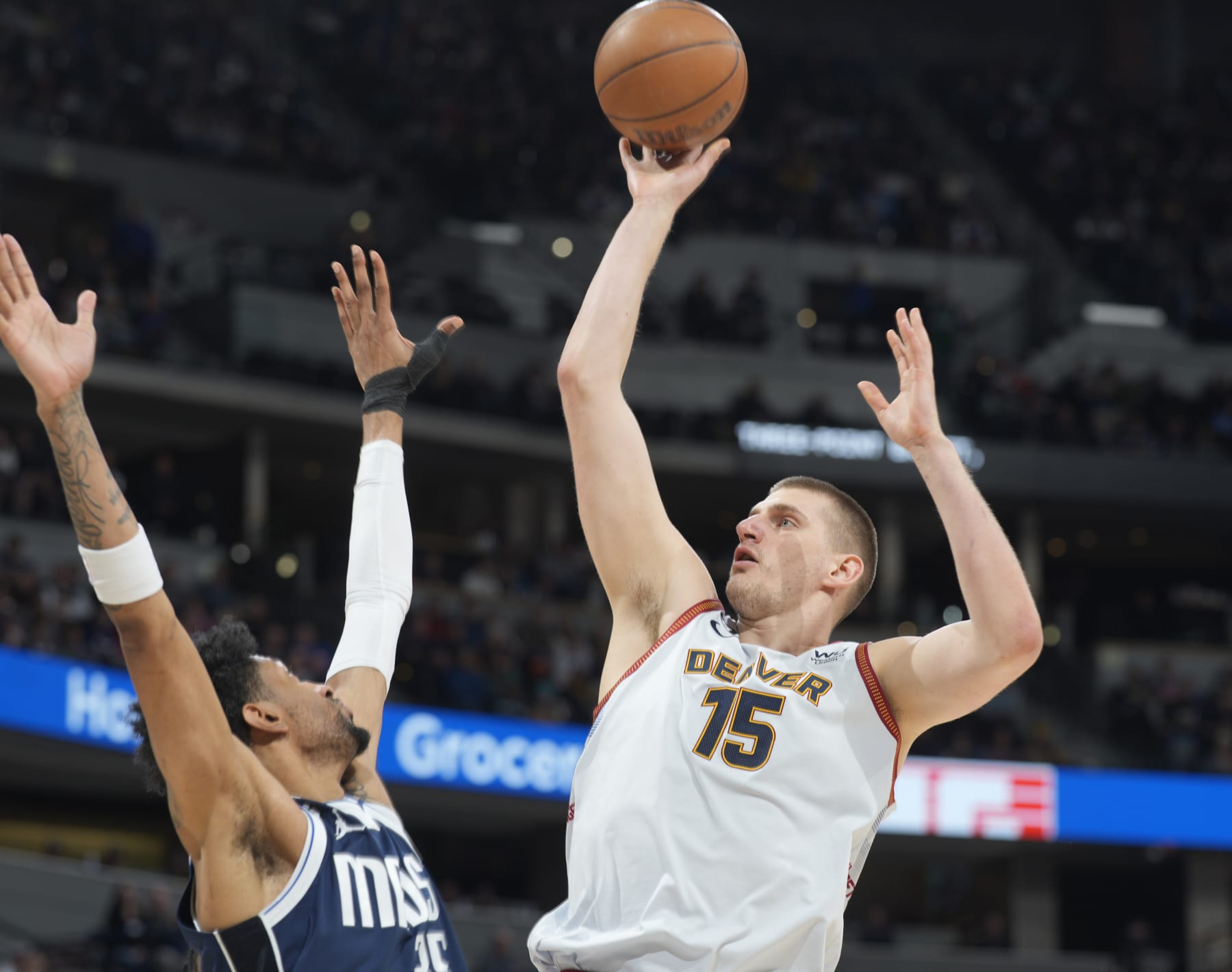 Denver Nuggets center Nikola Jokic, right, goes up for a basket over Dallas Mavericks forward Christian Wood in the second half of an NBA basketball game Wednesday, Feb. 15, 2023, in Denver. (AP Photo/David Zalubowski) Denver Nuggets center Nikola Jokic, right, goes up for a basket over Dallas Mavericks forward Christian Wood in the second half of an NBA basketball game Wednesday, Feb. 15, 2023, in Denver. (AP Photo/David Zalubowski)
