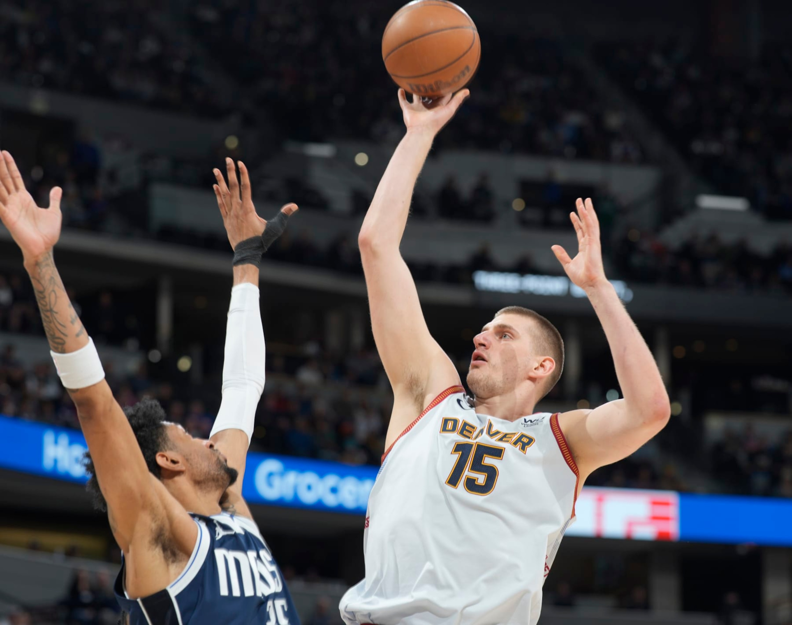 Denver Nuggets center Nikola Jokic, right, goes up for a basket over Dallas Mavericks forward Christian Wood in the second half of an NBA basketball game Wednesday, Feb. 15, 2023, in Denver. (AP Photo/David Zalubowski)