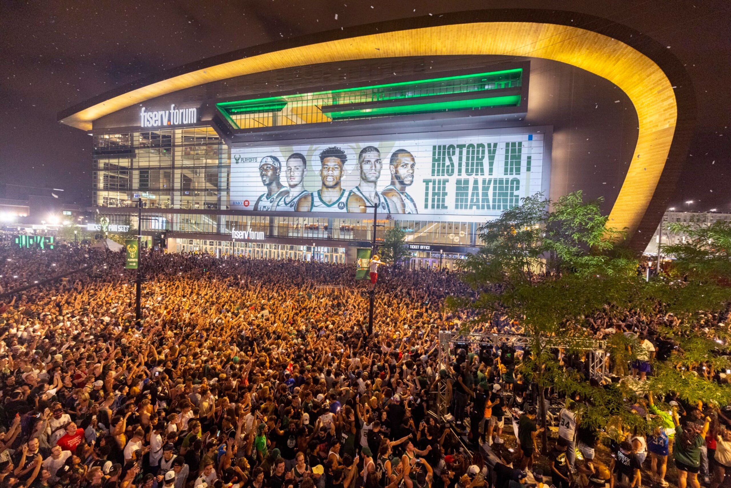 FILE - Fans cheer outside Fiserv Forum after the Milwaukee Bucks defeated the Phoenix Suns in Game 6 of the NBA basketball finals to win the NBA championship Tuesday, July 20, 2021, in Milwaukee. (AP Photo/Jeffrey Phelps) FILE - Fans cheer outside Fiserv Forum after the Milwaukee Bucks defeated the Phoenix Suns in Game 6 of the NBA basketball finals to win the NBA championship Tuesday, July 20, 2021, in Milwaukee. (AP Photo/Jeffrey Phelps)