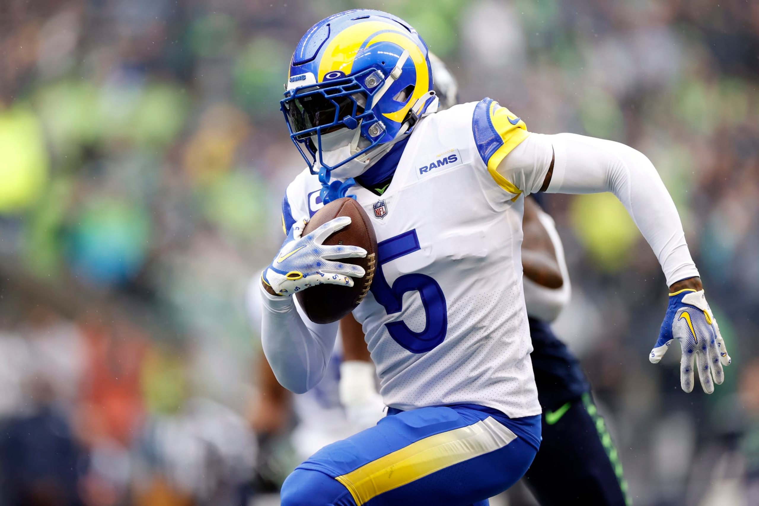 SEATTLE, WASHINGTON - JANUARY 08: Jalen Ramsey #5 of the Los Angeles Rams runs with the ball after making an interception during the first quarter against the Seattle Seahawks at Lumen Field on January 08, 2023 in Seattle, Washington. (Photo by Steph Chambers/Getty Images)