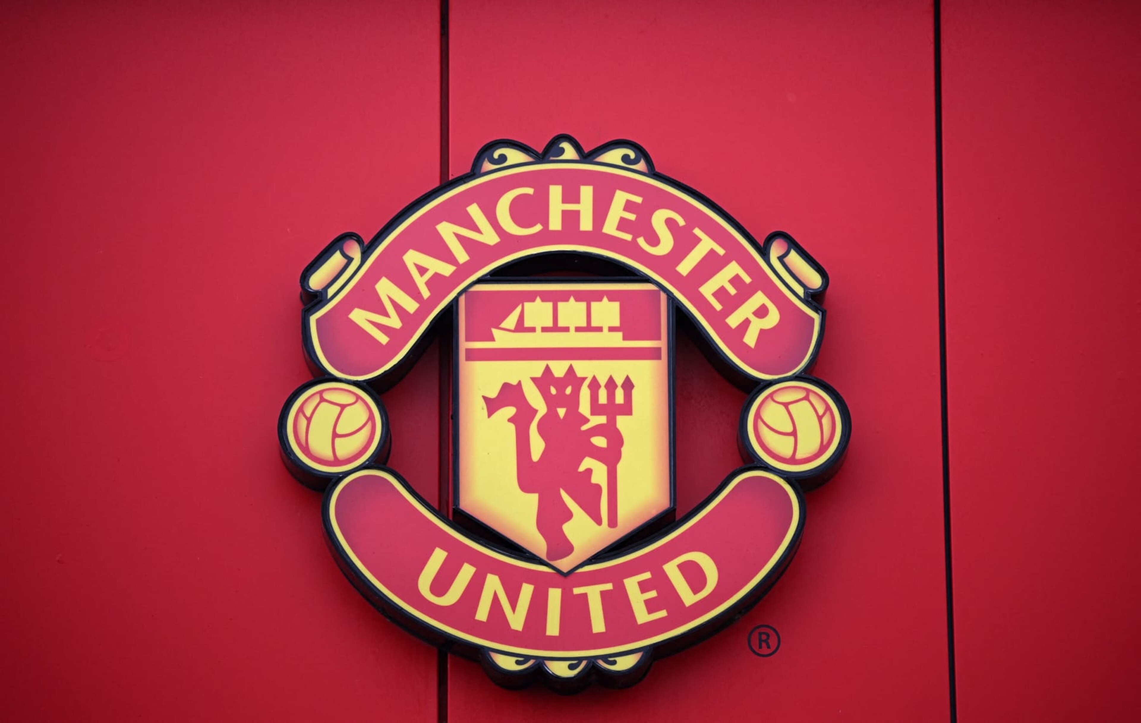 A Manchester United logo is pictured outside of Old Trafford stadium, home ground of Manchester United football team, in Manchester, northern England, on November 23, 2022. - Manchester United's owners said Tuesday they were ready to sell the club after it was earlier confirmed star player Cristiano Ronaldo was leaving the Premier League giants. Weeks of turbulence at Old Trafford appeared to have come to an end when the club announced Ronaldo was leaving with "immediate effect". (Photo by Oli SCARFF / AFP) (Photo by OLI SCARFF/AFP via Getty Images)