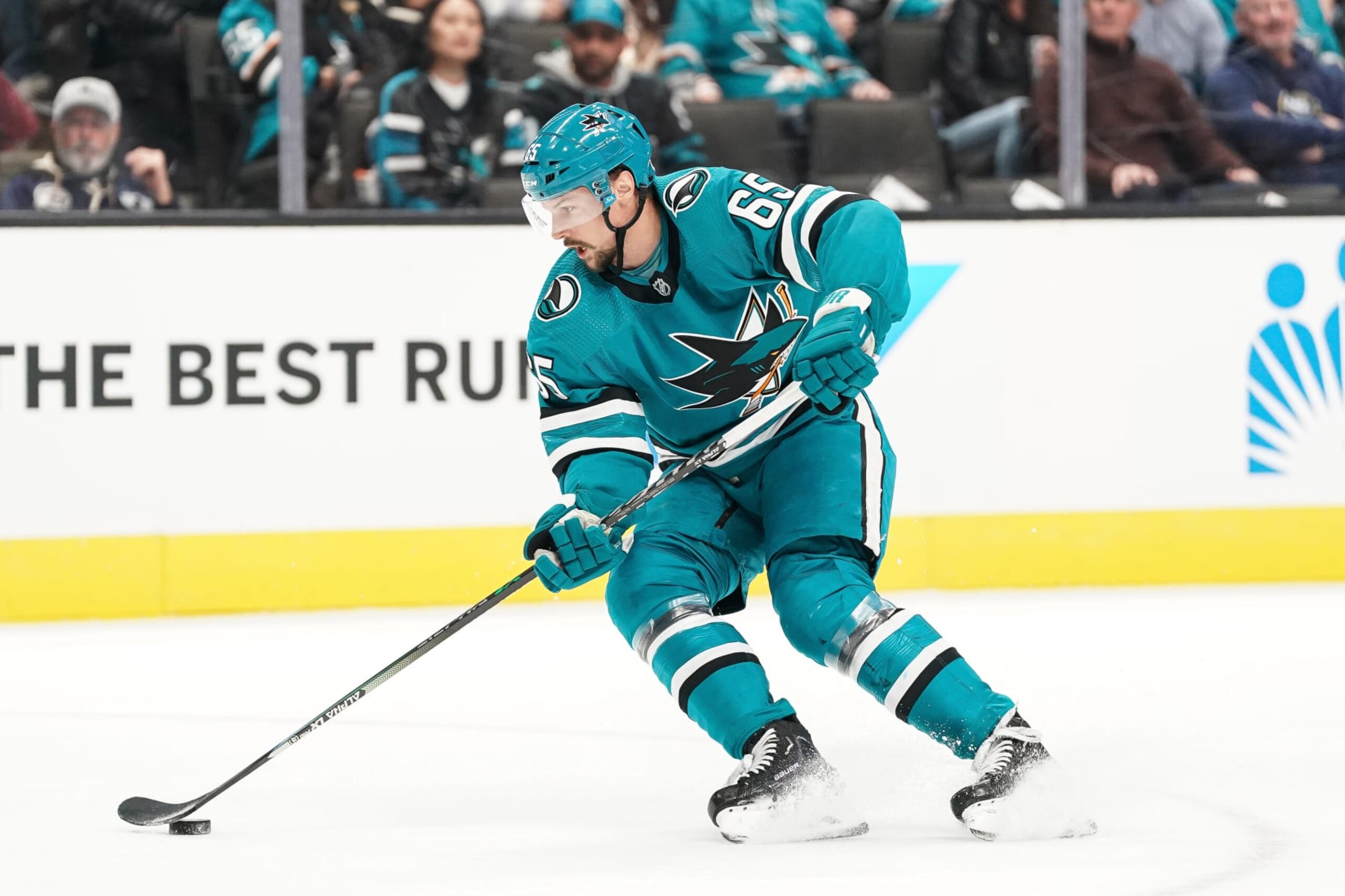 SAN JOSE, CA - FEBRUARY 18: Erik Karlsson #65 of the San Jose Sharks skates with the puck against the Buffalo Sabres at SAP Center on February 18, 2023 in San Jose, California. (Photo by Kavin Mistry/NHLI via Getty Images)