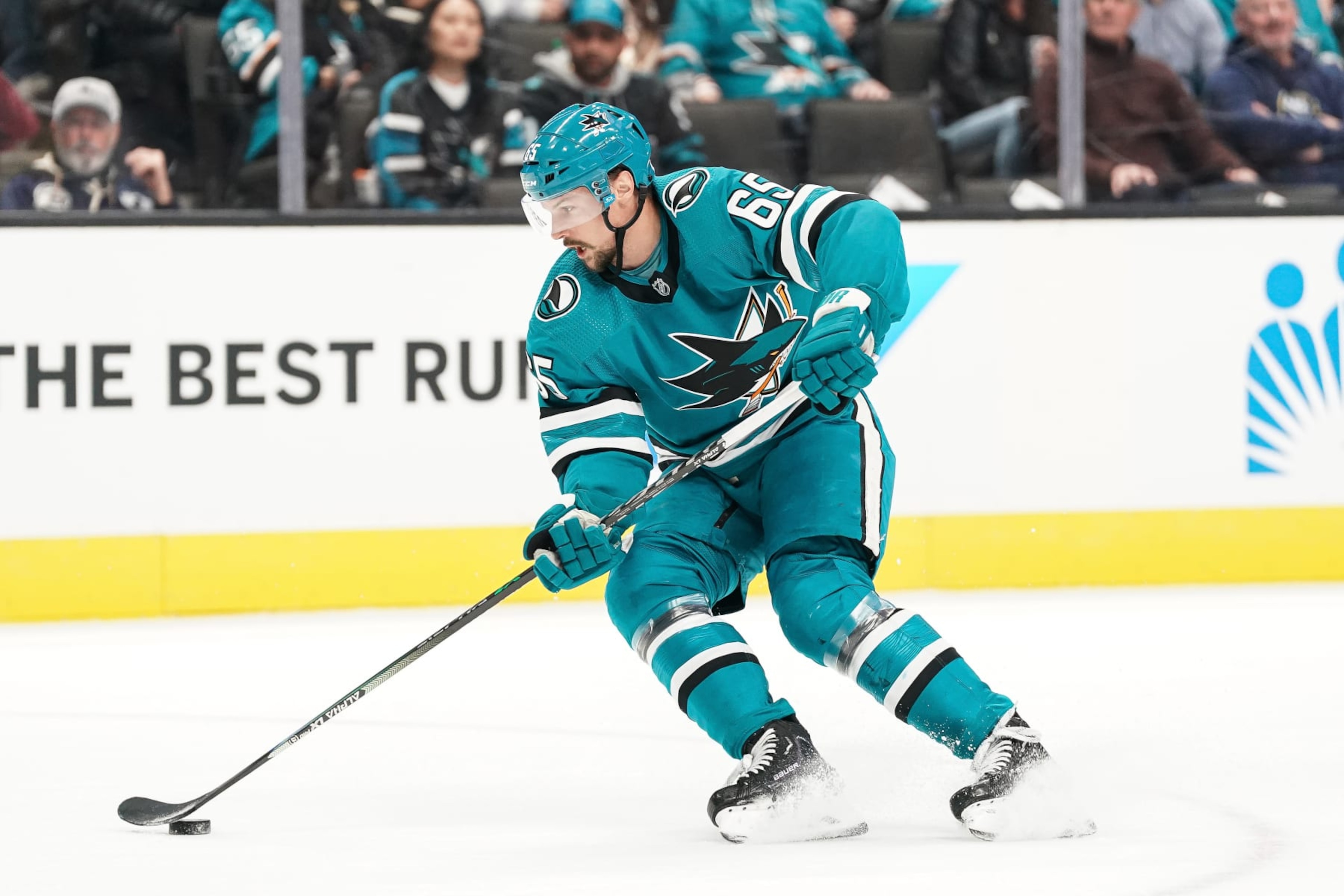 SAN JOSE, CA - FEBRUARY 18: Erik Karlsson #65 of the San Jose Sharks skates with the puck against the Buffalo Sabres at SAP Center on February 18, 2023 in San Jose, California. (Photo by Kavin Mistry/NHLI via Getty Images)