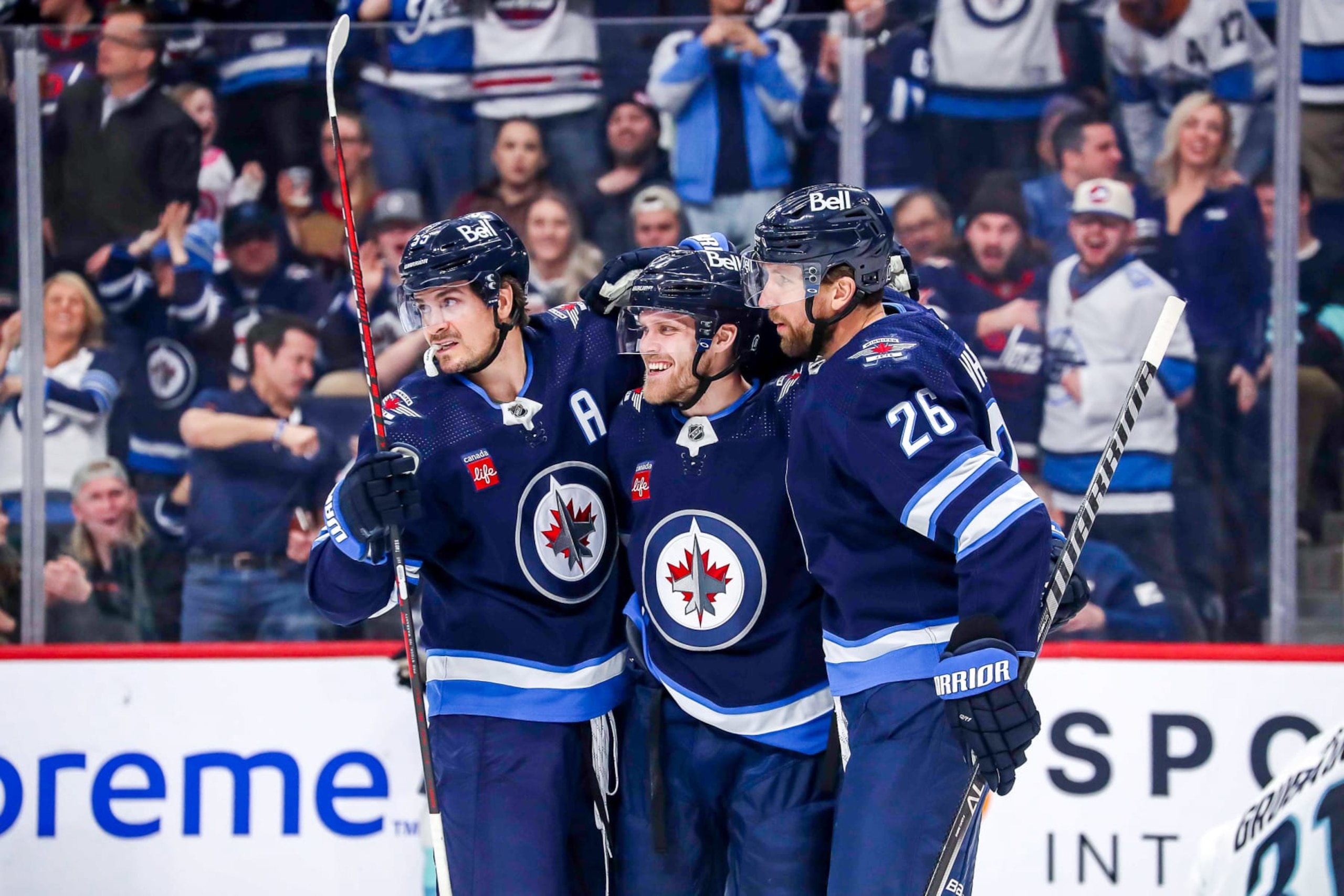 WINNIPEG, CANADA - FEBRUARY 14: Mark Scheifele #55, Nikolaj Ehlers #27 and Blake Wheeler #26 of the Winnipeg Jets celebrate a second period goal against the Seattle Kraken at the Canada Life Centre on February 14, 2023 in Winnipeg, Manitoba, Canada. (Photo by Darcy Finley/NHLI via Getty Images) WINNIPEG, CANADA - FEBRUARY 14: Mark Scheifele #55, Nikolaj Ehlers #27 and Blake Wheeler #26 of the Winnipeg Jets celebrate a second period goal against the Seattle Kraken at the Canada Life Centre on February 14, 2023 in Winnipeg, Manitoba, Canada. (Photo by Darcy Finley/NHLI via Getty Images)