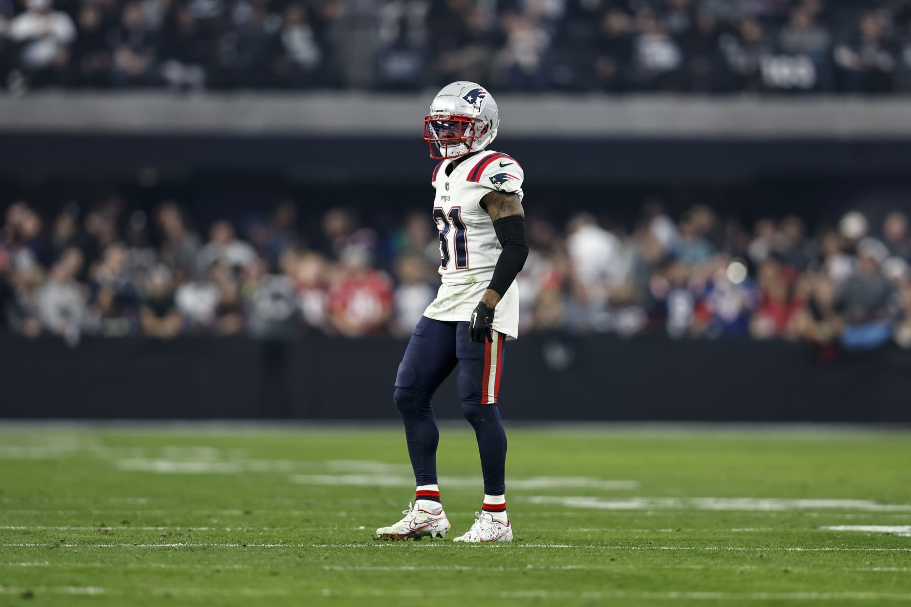 LAS VEGAS, NEVADA - DECEMBER 18: Jonathan Jones #31 of the New England Patriots looks on during an NFL football game between the Las Vegas Raiders and the New England Patriots at Allegiant Stadium on December 18, 2022 in Las Vegas, Nevada. (Photo by Michael Owens/Getty Images)