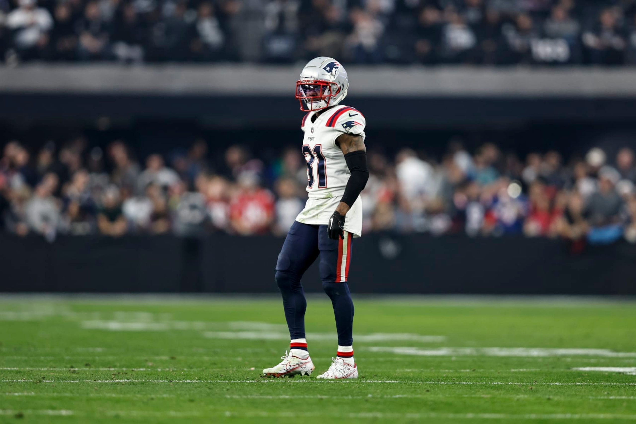 LAS VEGAS, NEVADA - DECEMBER 18: Jonathan Jones #31 of the New England Patriots looks on during an NFL football game between the Las Vegas Raiders and the New England Patriots at Allegiant Stadium on December 18, 2022 in Las Vegas, Nevada. (Photo by Michael Owens/Getty Images)