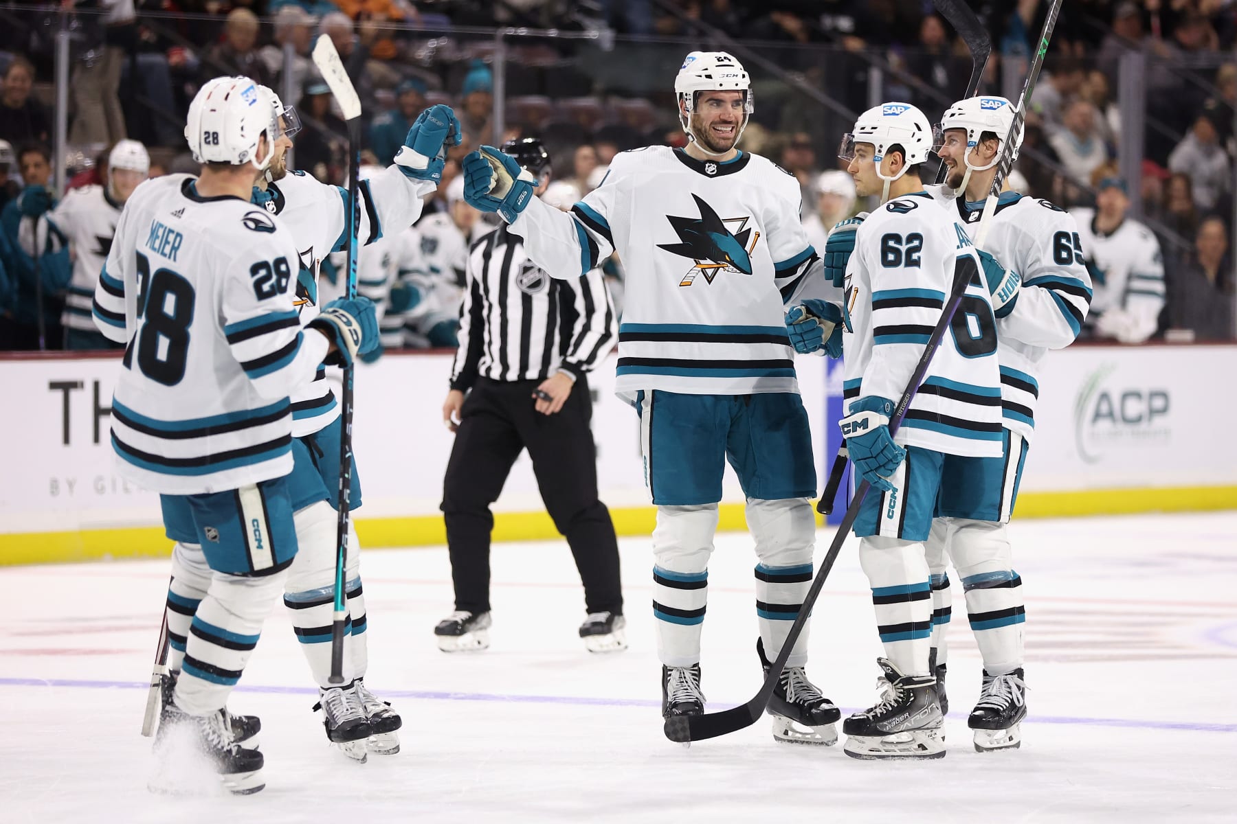 TEMPE, ARIZONA - JANUARY 10: Jaycob Megna #24 of the San Jose Sharks is congratulated by Timo Meier #28, Tomas Hertl #48, Kevin Labanc #62 and Erik Karlsson #65 after scoring a goal against the Arizona Coyotes during the third period of the NHL game at Mullett Arena on January 10, 2023 in Tempe, Arizona. The Sharks defeated the Coyotes 4-2.  (Photo by Christian Petersen/Getty Images)