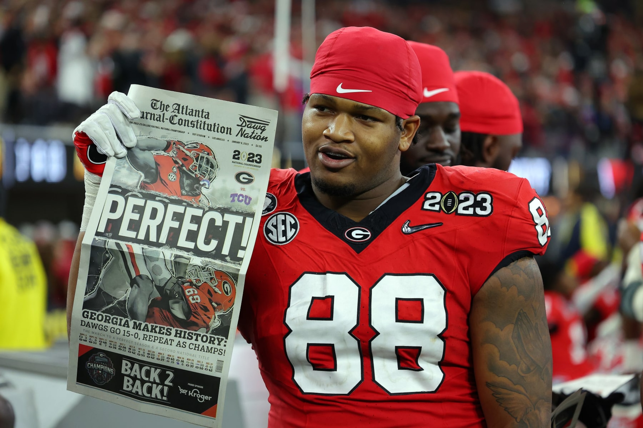 INGLEWOOD, CALIFORNIA - JANUARY 09: Jalen Carter #88 of the Georgia Bulldogs celebrates with a newspaper reading "Perfect!" after defeating the TCU Horned Frogs in the College Football Playoff National Championship game at SoFi Stadium on January 09, 2023 in Inglewood, California. Georgia defeated TCU 65-7. (Photo by Kevin C. Cox/Getty Images)