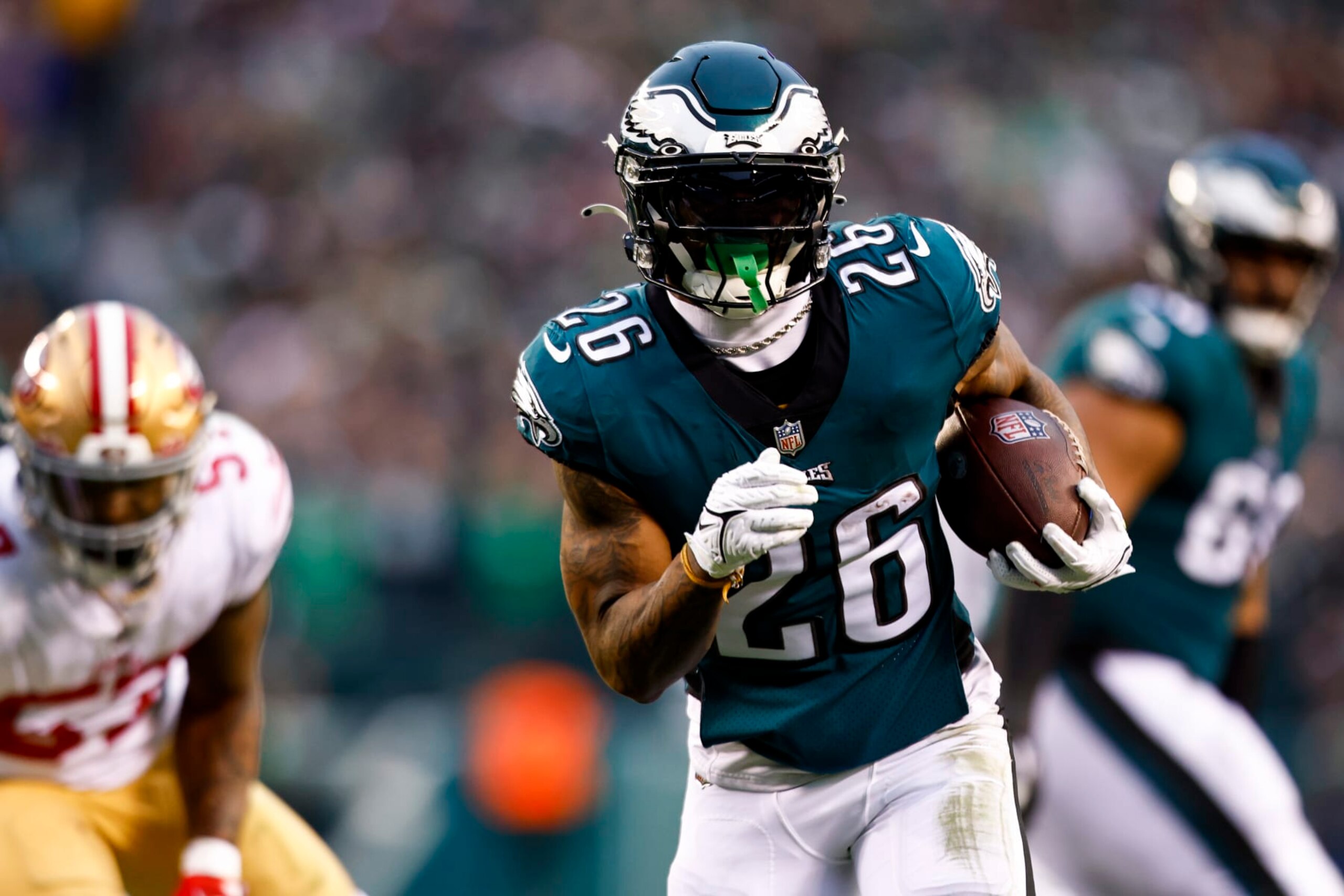 PHILADELPHIA, PA - JANUARY 29: Miles Sanders #26 of the Philadelphia Eagles carries the ball to score a touchdown during the second quarter of the NFC Championship NFL football game against the San Francisco 49ers at Lincoln Financial Field on January 29, 2023 in Philadelphia, Pennsylvania. (Photo by Kevin Sabitus/Getty Images)
