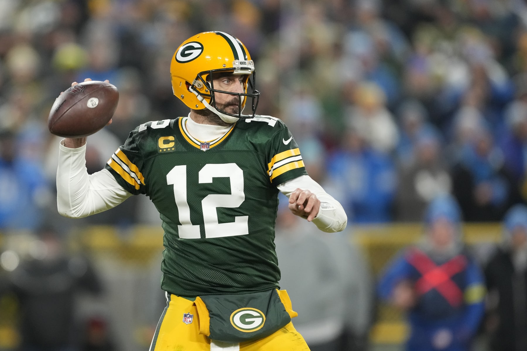 GREEN BAY, WISCONSIN - JANUARY 08: Aaron Rodgers #12 of the Green Bay Packers looks to the throw the pass against the Detroit Lions in the second half at Lambeau Field on January 08, 2023 in Green Bay, Wisconsin. (Photo by Patrick McDermott/Getty Images)