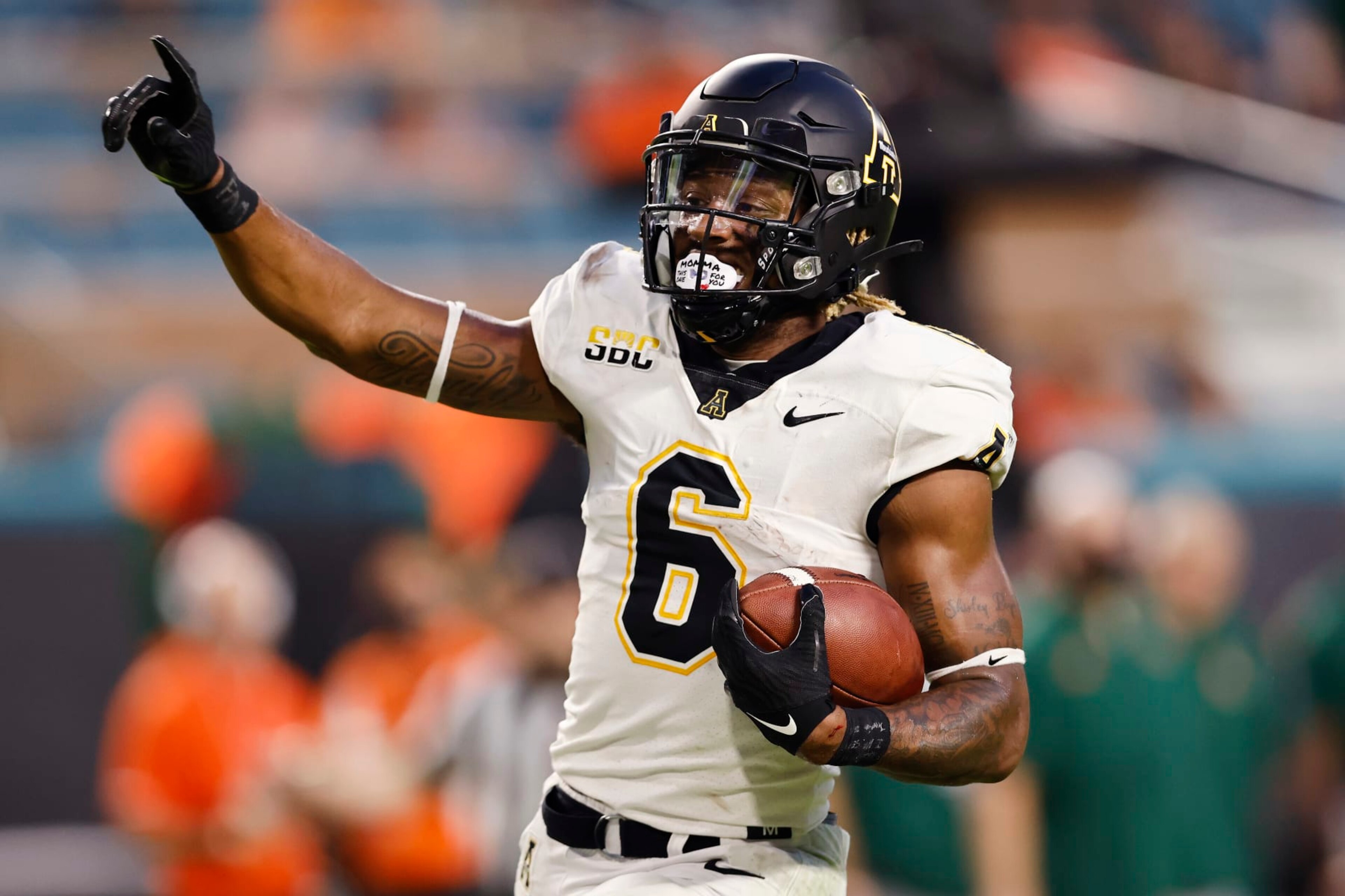 MIAMI GARDENS, FLORIDA - SEPTEMBER 11: Camerun Peoples #6 of the Appalachian State Mountaineers celebrates a 28-yard touchdown run against the Miami Hurricanes during the first quarter at Hard Rock Stadium on September 11, 2021 in Miami Gardens, Florida. (Photo by Michael Reaves/Getty Images)