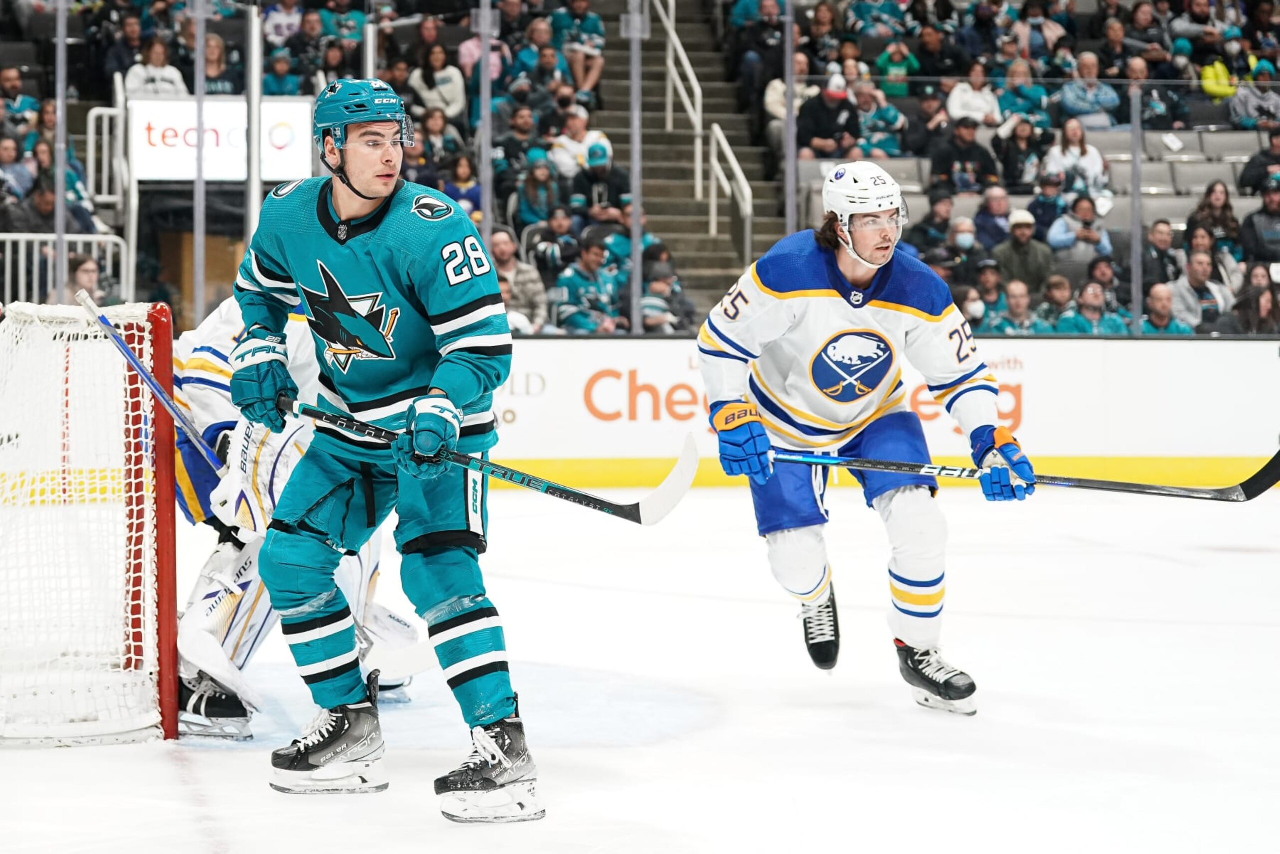 SAN JOSE, CA - FEBRUARY 18: Timo Meier #28 of the San Jose Sharks looks for the puck against Owen Power #25 of the Buffalo Sabres at SAP Center on February 18, 2023 in San Jose, California. (Photo by Kavin Mistry/NHLI via Getty Images)
