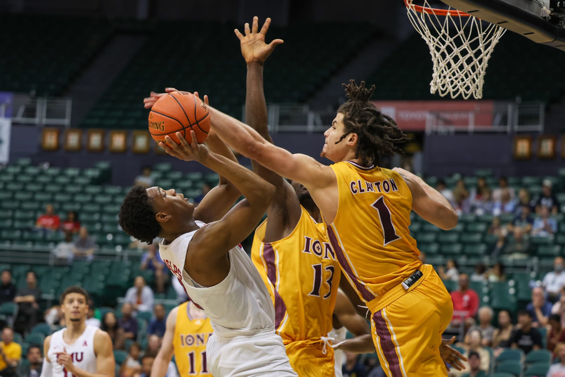 HONOLULU, HI - DECEMBER 22: Zhuric Phelps #1 of the SMU Mustangs has his shot blocked by Walter Clayton Jr. #1 of the Iona Gaels during the second half of the Hawaiian Airlines Diamond Head Classic game at SimpliFi Arena on December 22, 2022 in Honolulu, Hawaii. (Photo by Darryl Oumi/Getty Images)