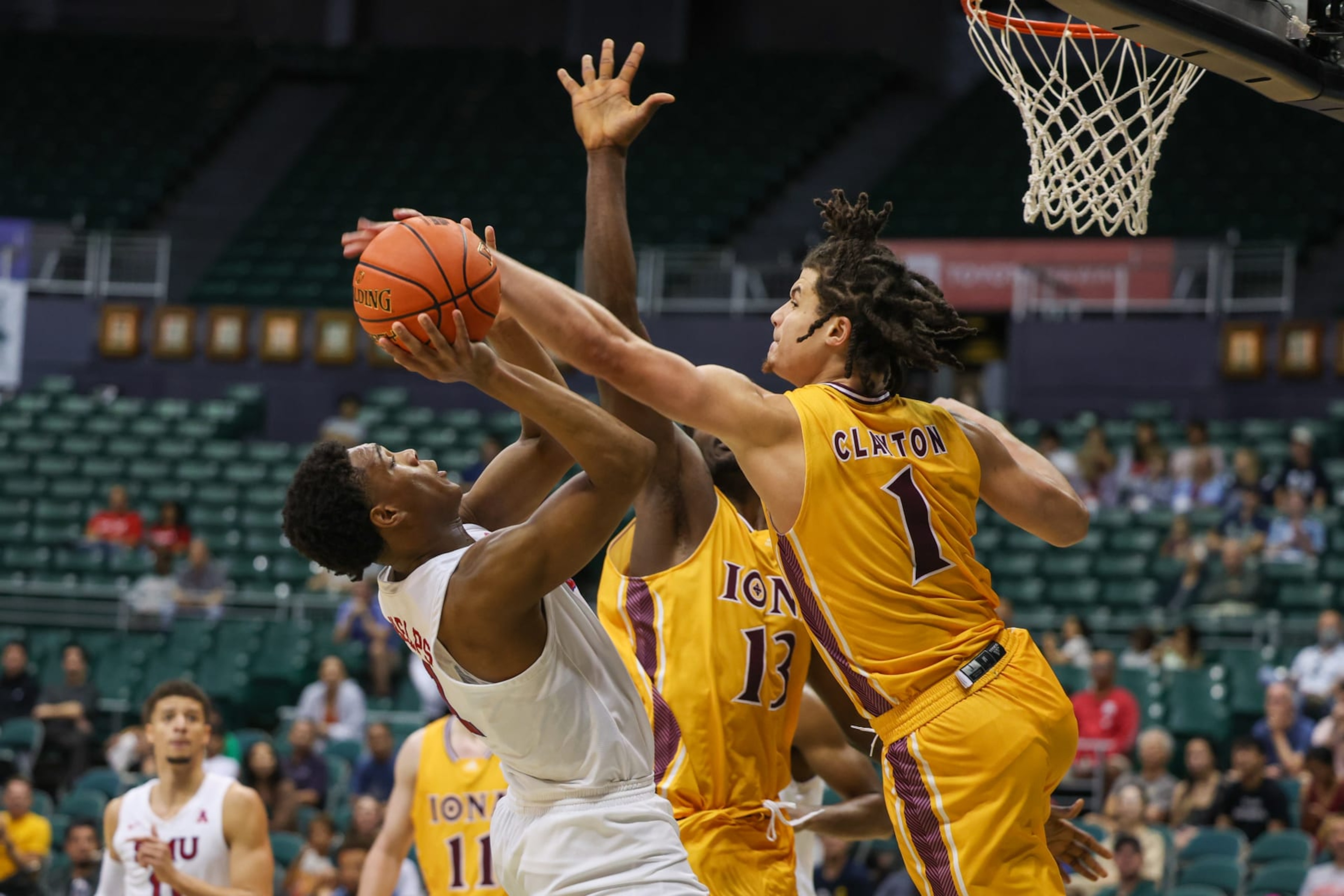 HONOLULU, HI - DECEMBER 22: Zhuric Phelps #1 of the SMU Mustangs has his shot blocked by Walter Clayton Jr. #1 of the Iona Gaels during the second half of the Hawaiian Airlines Diamond Head Classic game at SimpliFi Arena on December 22, 2022 in Honolulu, Hawaii. (Photo by Darryl Oumi/Getty Images) HONOLULU, HI - DECEMBER 22: Zhuric Phelps #1 of the SMU Mustangs has his shot blocked by Walter Clayton Jr. #1 of the Iona Gaels during the second half of the Hawaiian Airlines Diamond Head Classic game at SimpliFi Arena on December 22, 2022 in Honolulu, Hawaii. (Photo by Darryl Oumi/Getty Images)